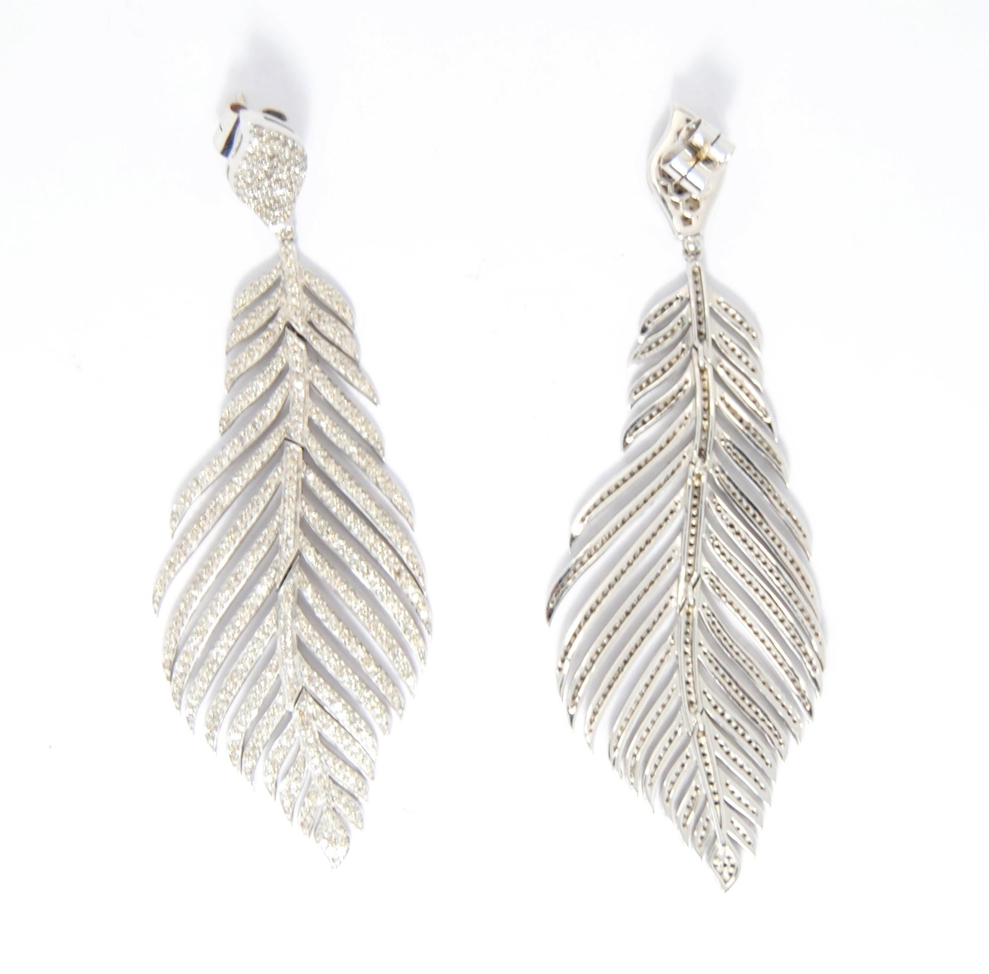 Irama Pradera is a Young designer from Spain that searches always for the best gems and combines classic with contemporary mounting and styles. 
Sleekly crafted in 18K white gold and silver  these classic roman leaf motif mounted with 932 pavé