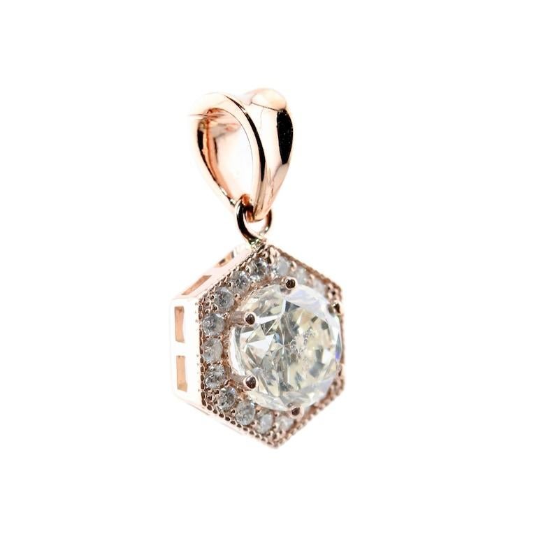Aston Estate Jewelry Presents:

A sparkling diamond pendant necklace in 14 karat rose gold. Centered by a 1.09 carat round brilliant cut diamond of I color, with I1 clarity. Set in a hexagon shaped rose gold mount accented by 0.14 carats of pave set