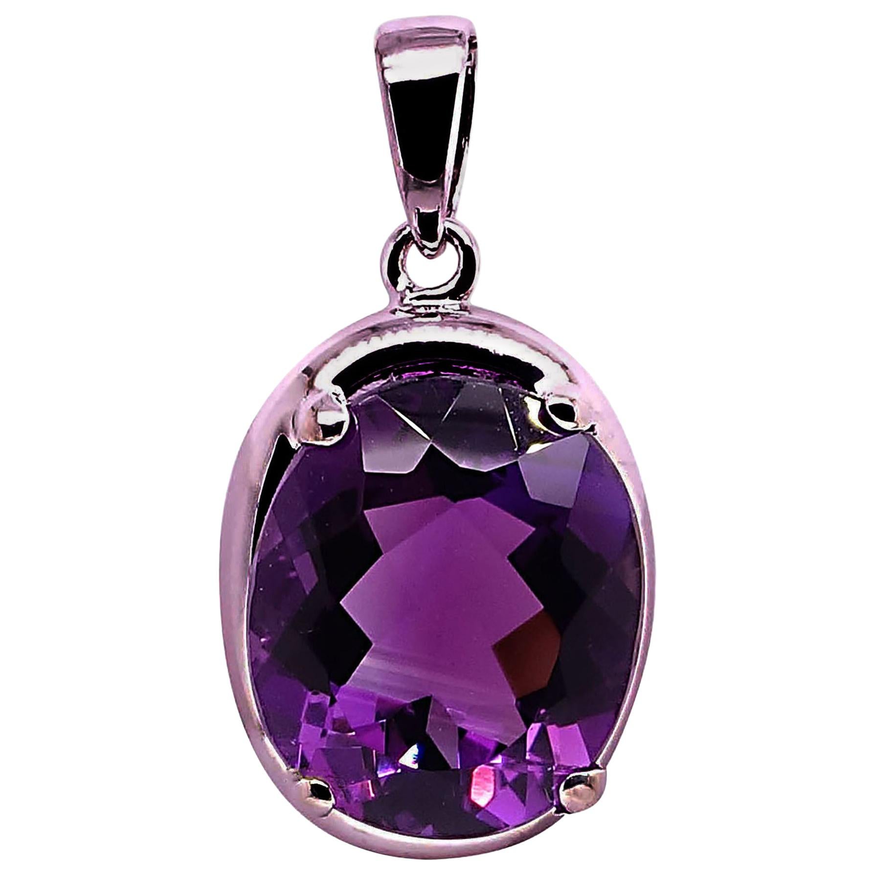 Unique pendant of sparkling oval Amethyst with pink flash set in Sterling Silver. Delightful deep purple Amethyst with a pink flash pendant for all you Amethyst lovers.  The Amethyst is approximately 6.53 carats and measures 15 x 10 MM.  The pendant