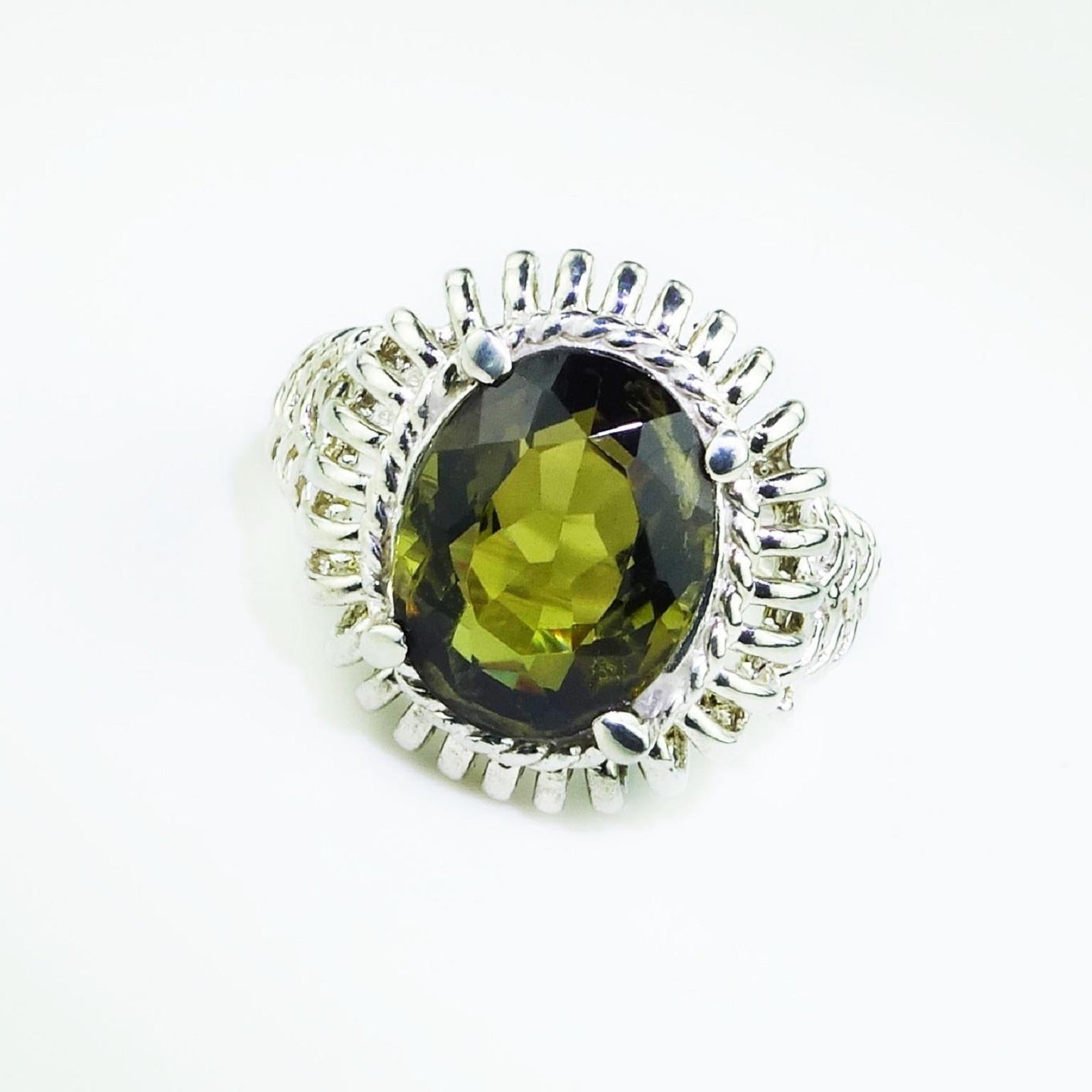 Custom made, lovely, sparkling Dichroic  Andalusite of 5.86ct set in Ornate Sterling Silver Basket with detail continuing down the ring shank. The oval Andalusite appears Green or Brown depending on the way you look at it,  because of its dichroic