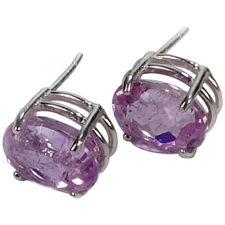 Sterling Silver Baskets hold sparkling oval Kunzite stud earrings. These bright and lively Brazilian Kunzites are 11mm x 9mm with a total weight of 9.6cts. Their brilliant cut and natural inclusions typical of Kunzite enhance the sparkle of these