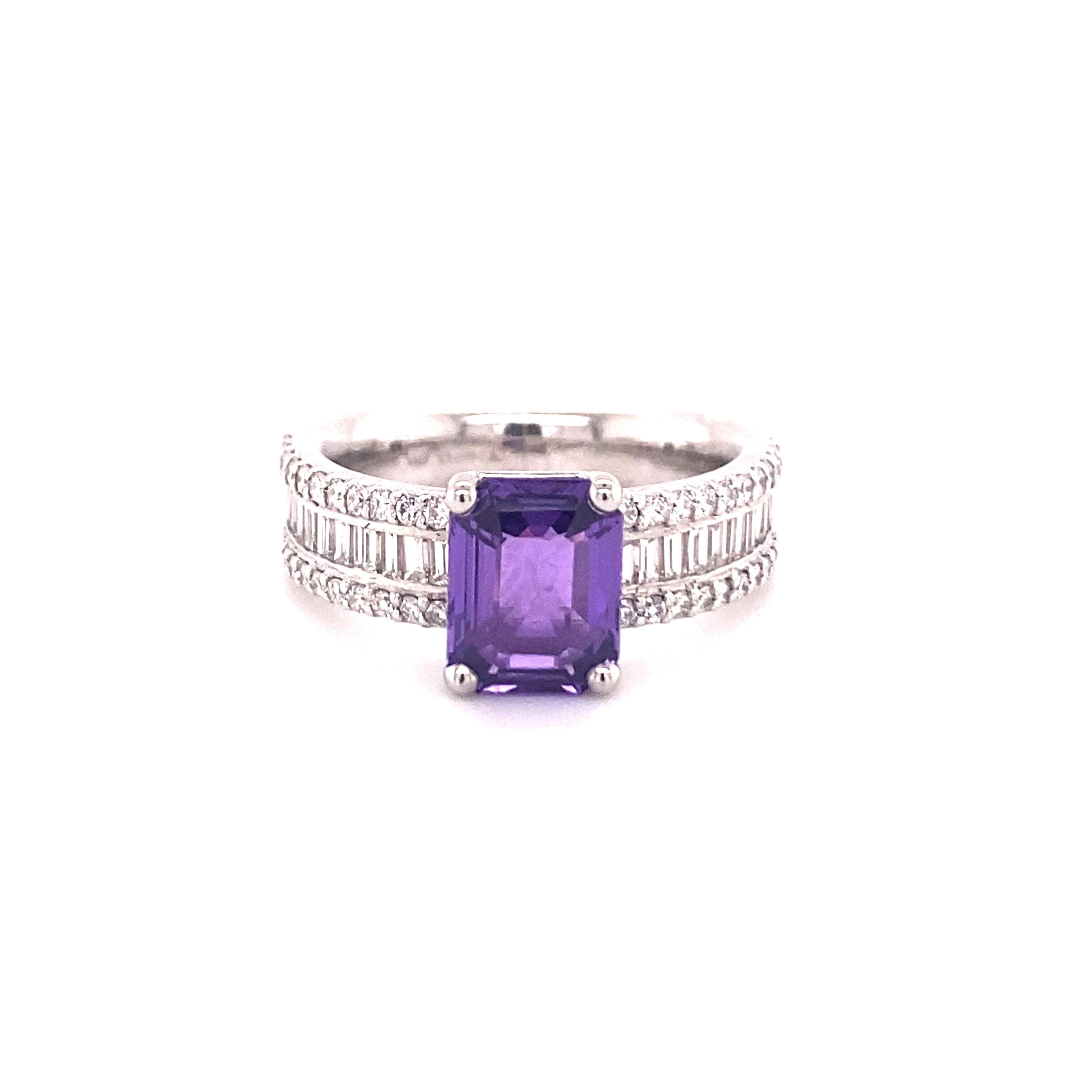 A beautiful untreated purple sapphire weighing 2.29 ct is set in this Platinum 950 ring.
22 baguette cut diamonds totalling 0.69 ct of G/H colour and vs clarity are repeating the rectangular shape. The contrast is made up of 44 brilliants totalling