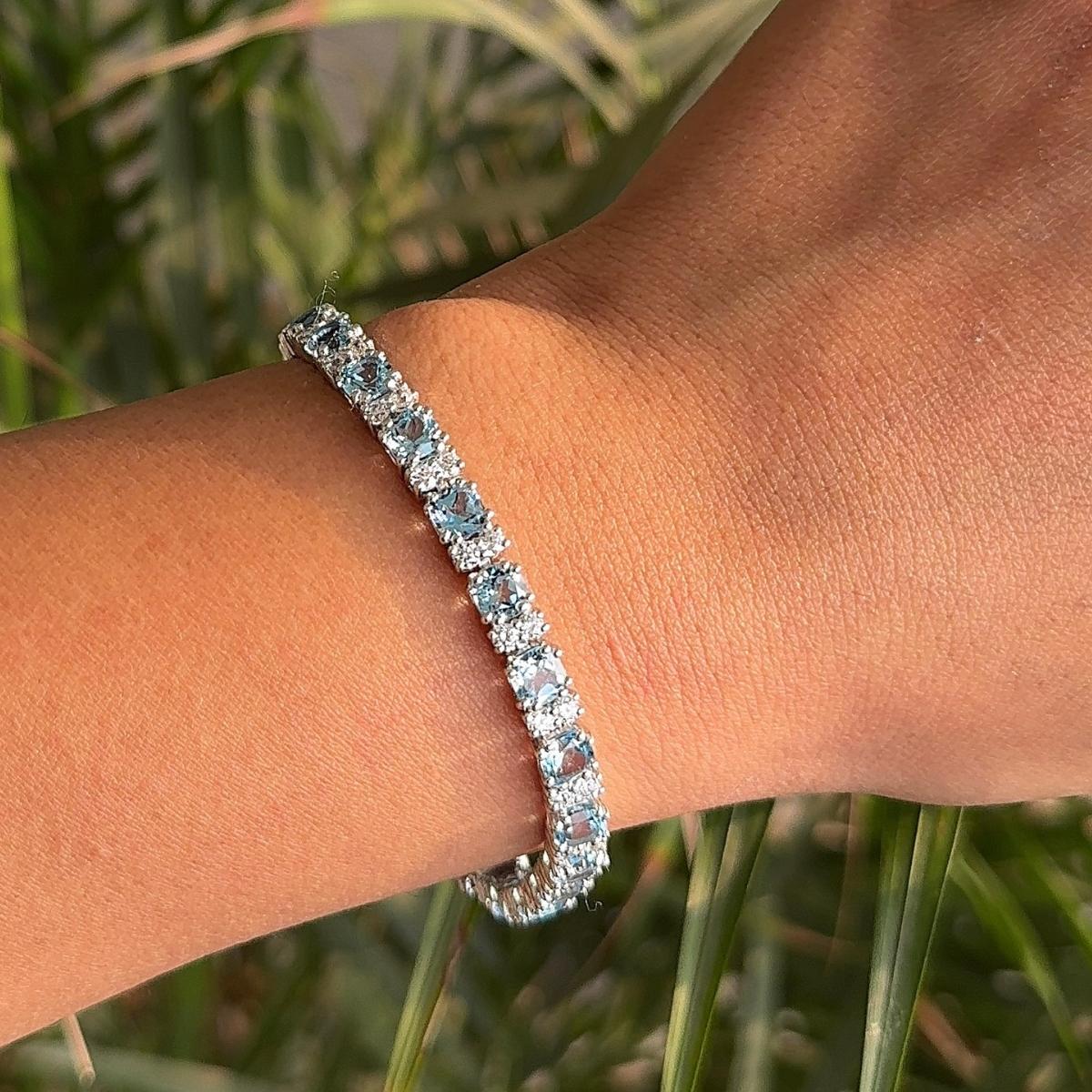 Sparkling Round Cut Blue Topaz Sterling Silver Tennis Bracelet in 925 Sterling Silver. You shall need statement tennis bracelet to make a statement with your look. Each piece features dazzling cubic zirconia stones, renowned for their brilliance and
