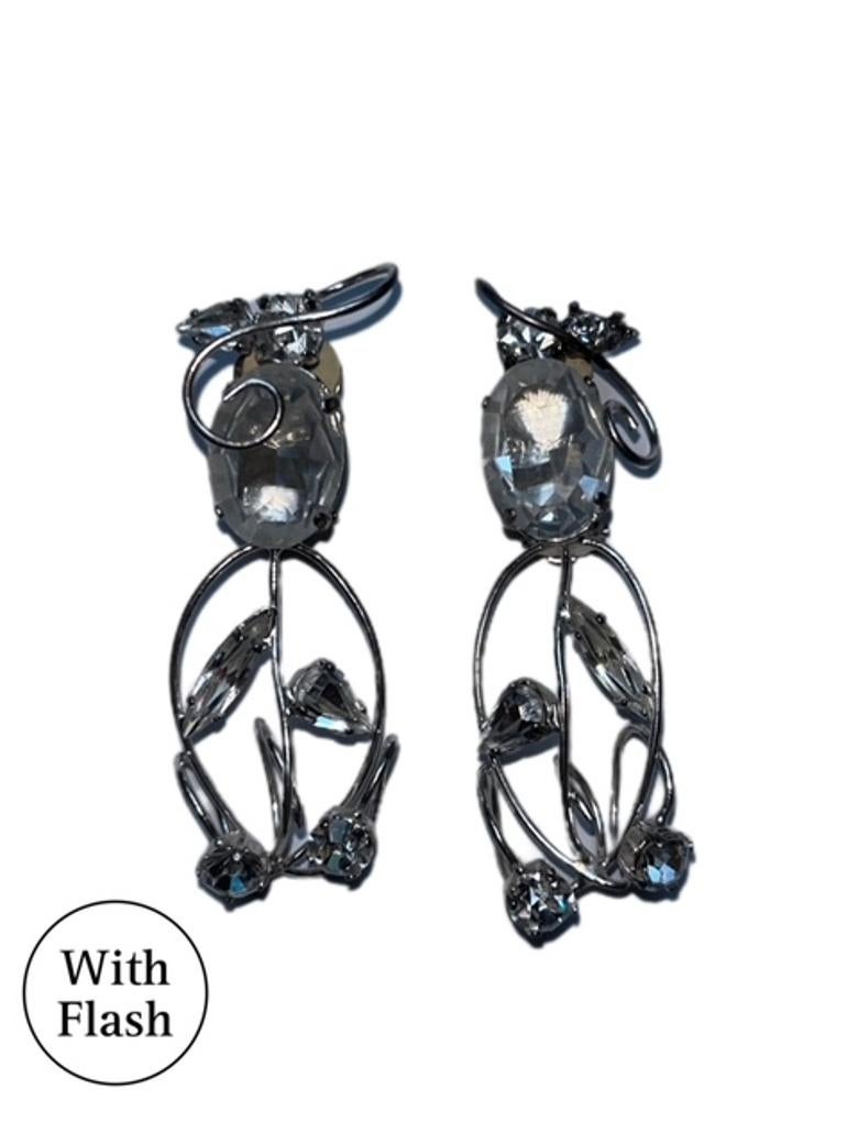 Add a touch of timeless elegance to your outfit with these vintage clip-on earrings, designed by Daniel Swarovski. The oval-cut crystal centrepiece is beautifully complemented by a floral-inspired swirl of smaller crystals with various cuts. Set in