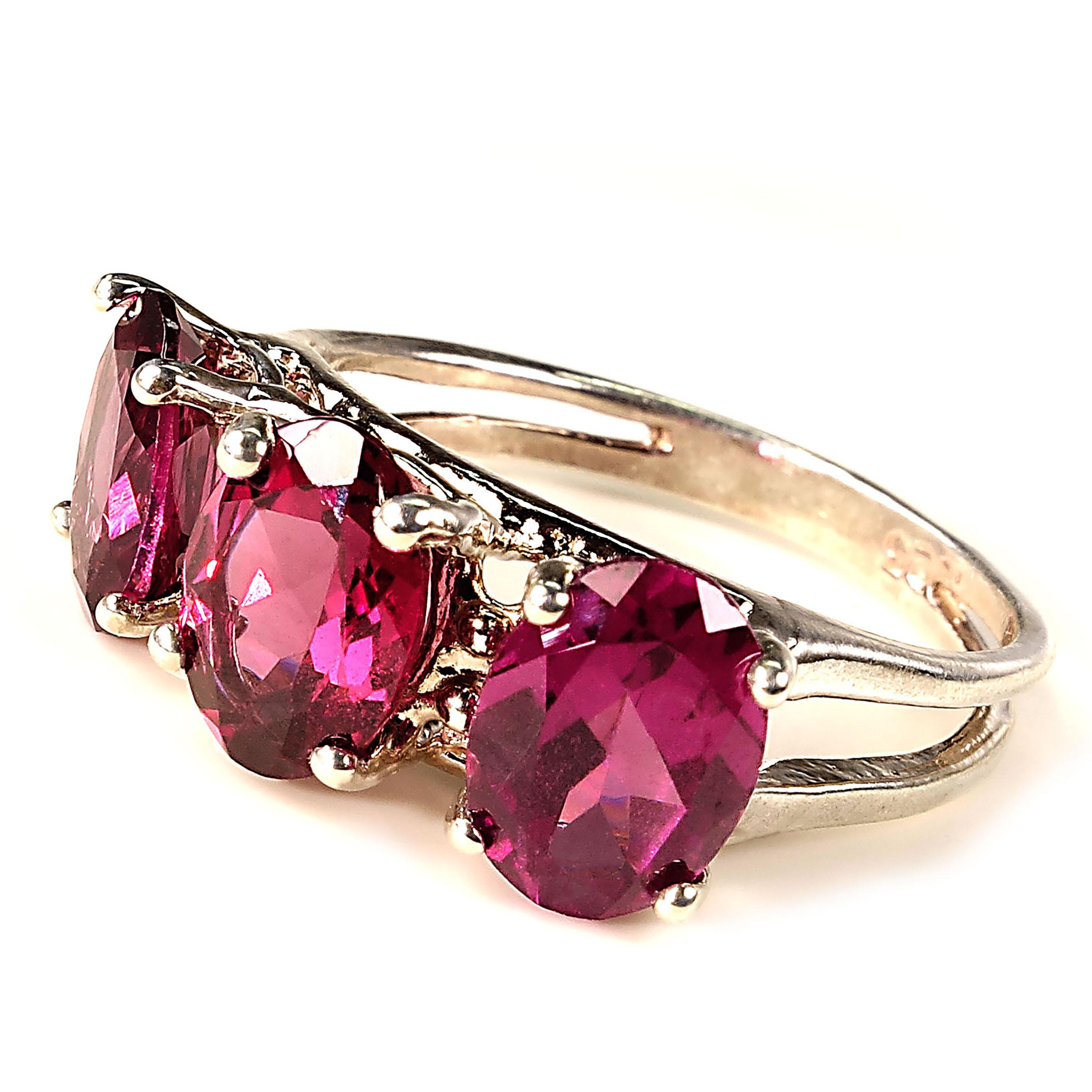 Custom made ring of three side by side sparkling oval  Rhodolite Garnets set in Sterling Silver.  These glorious Garnets are of a pinkish to purple shade of red Garnet in the pyrope family. The Rhodolite name comes from the Greek 'rhodon' as in
