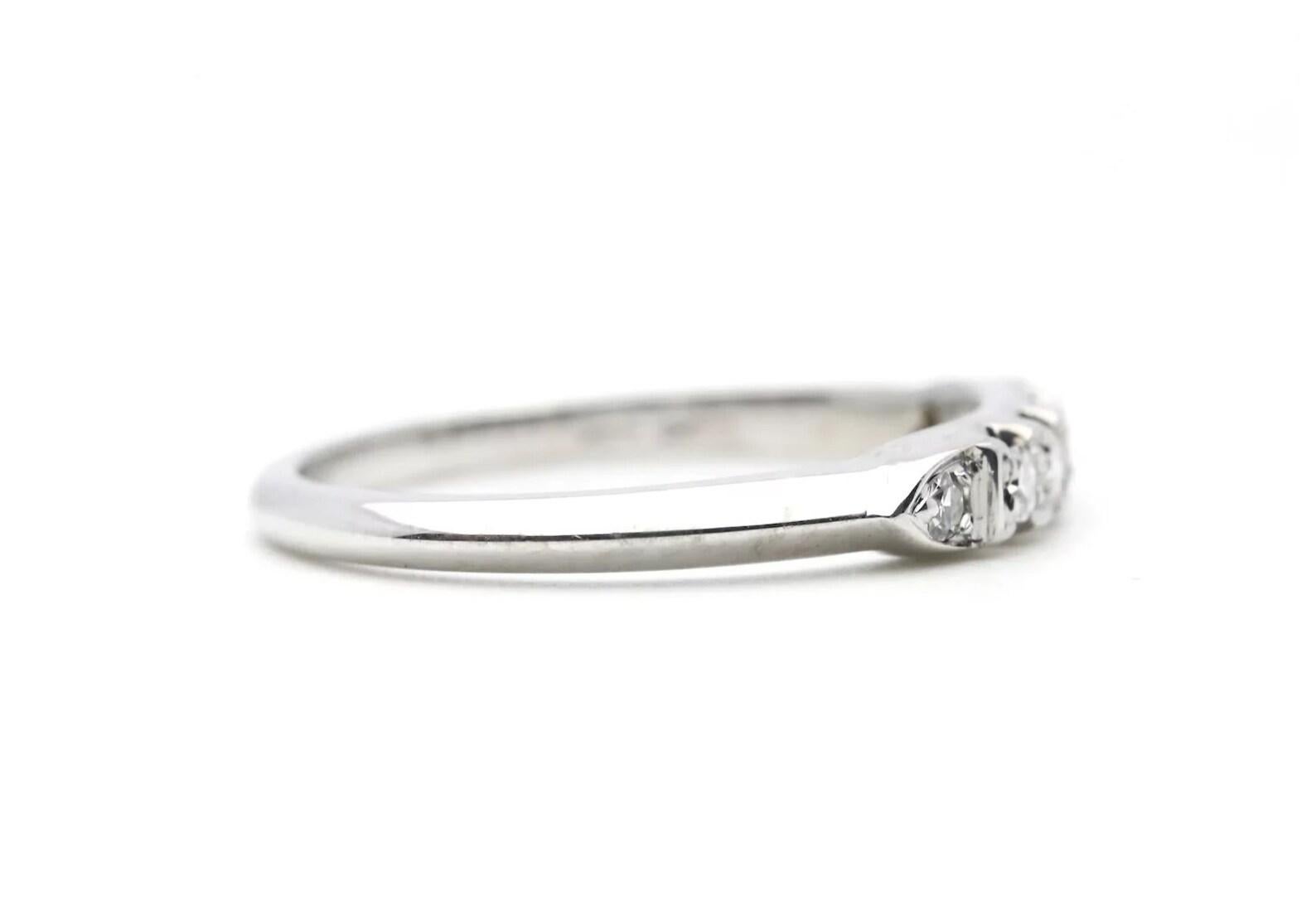 A vintage mid century period diamond wedding band in 18 karat white gold. This band features six round single cut diamonds weighing a combined 0.12 carats. The diamonds grade as G color, VS1 clarity.

In excellent condition, this ring is a size 6 US