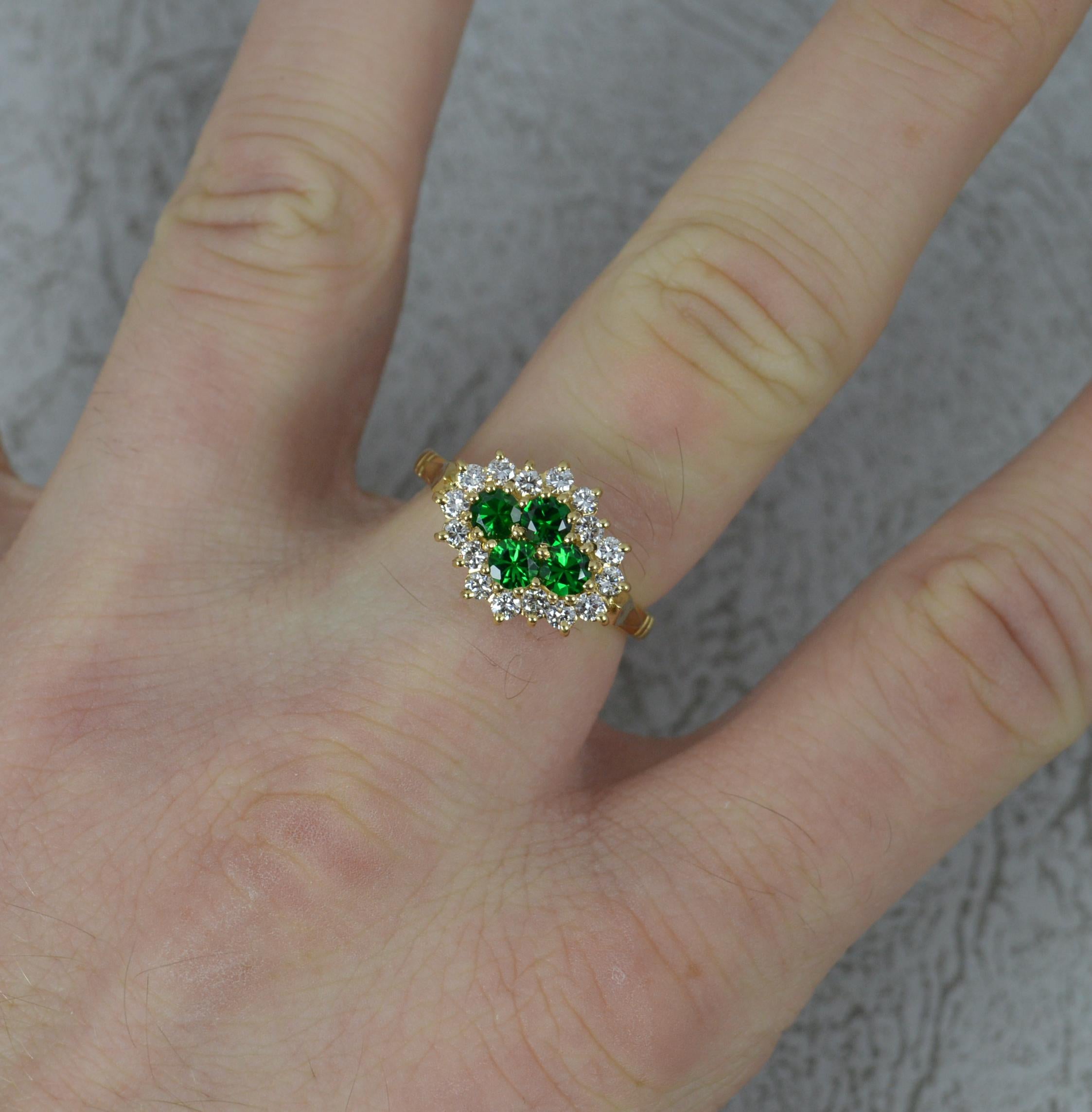 A superb contemporary cluster engagement ring.
Solid 18 carat yellow gold example.
Set with four round cut green garnet stones. Surrounded by a full border of 16 natural, round brilliant cut diamonds.
14mm x 11mm cluster head.

CONDITION ;