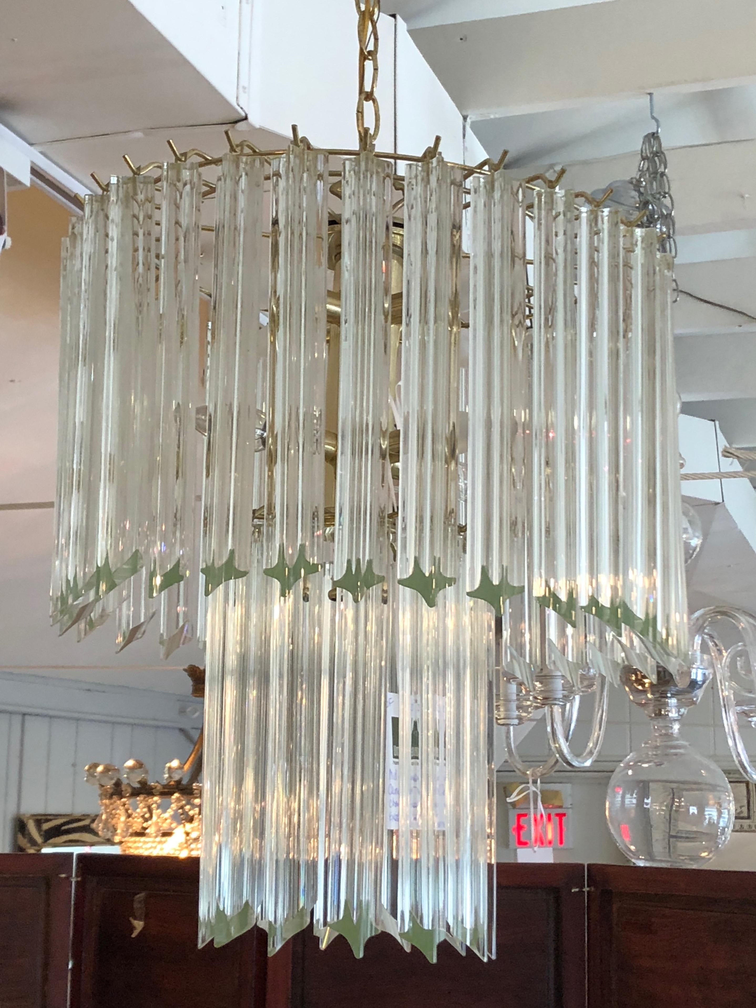 Iconic drippy Venini style chandelier by Camer having multiple chunky sculpted bars of crystal in elongated tiers, 9 sockets in all. Fixture itself is about 22 inches tall.
