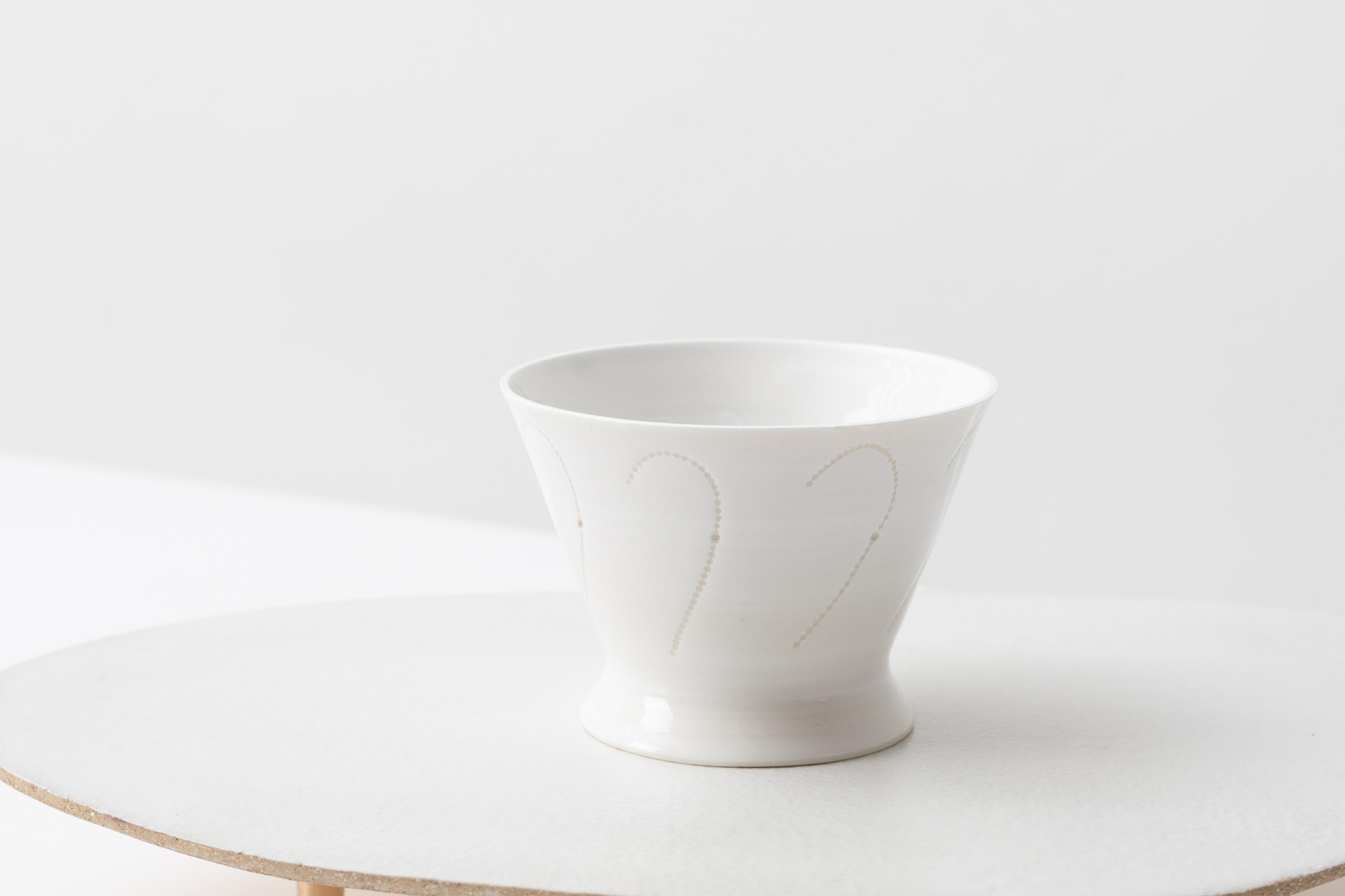 A thrown porcelain vessel on a glazed and gilded ceramic plinth by artist Christopher Riggio