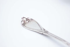 Spatula & fish fork in cut silver w/ raised handles surrounding monogram cards