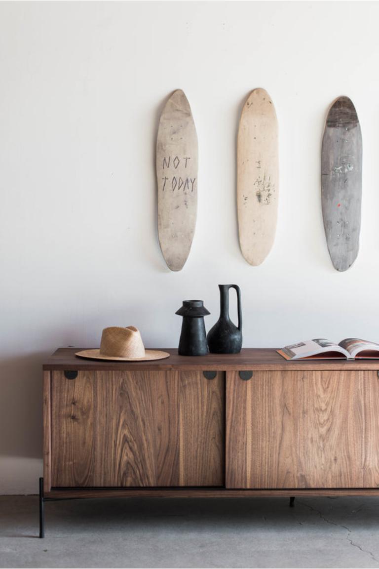 The Spaulding Credenza is handmade locally in Los Angeles, California. A variation on the classic Rivera Credenza, the piece combines natural material and modern design. The walnut casing and walnut doors are elevated by the clean metal detail at