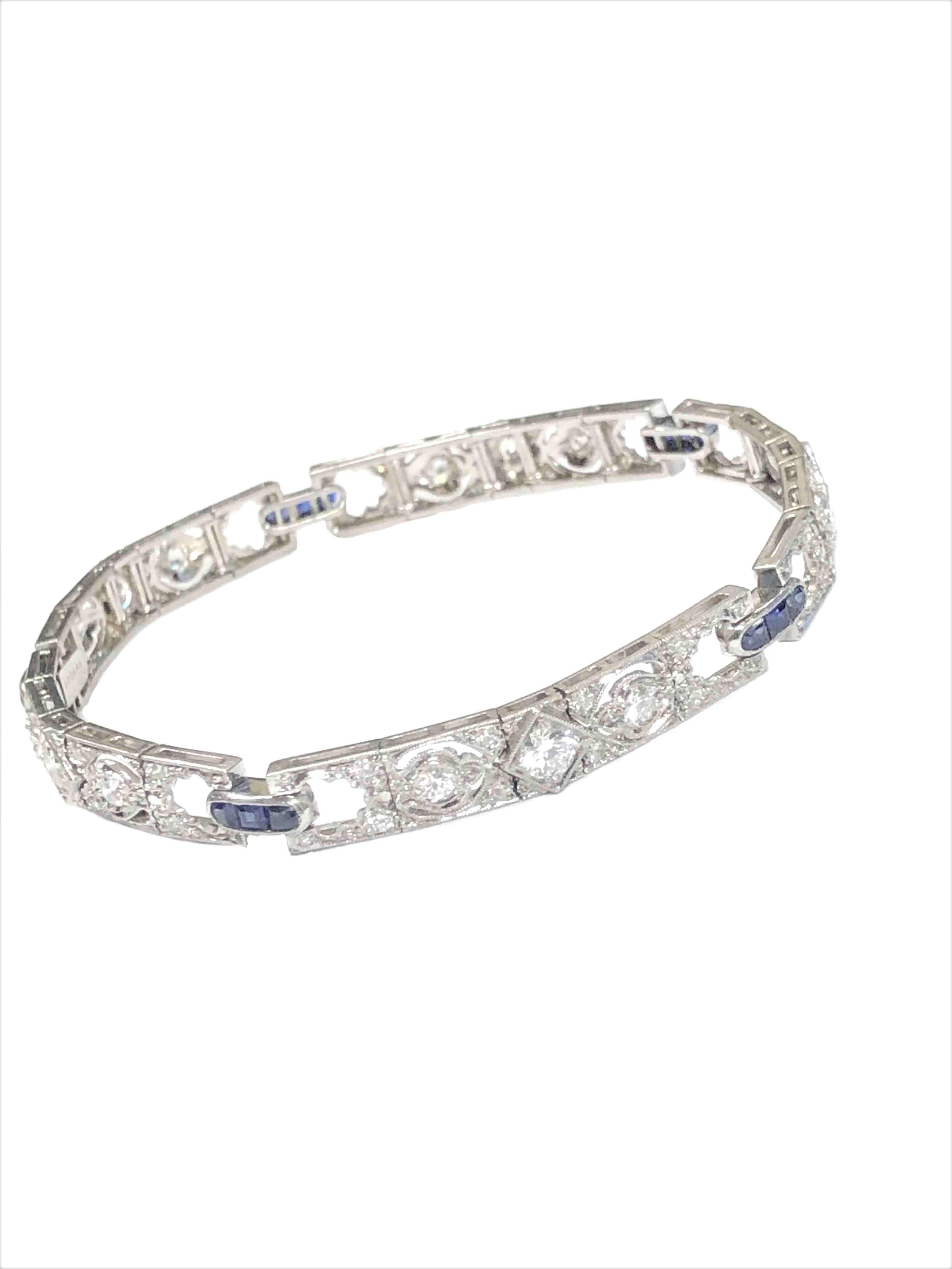 Circa 1930s Art Deco Signed Gorham bracelet for Spaulding Gorham, measuring 1/4 inch wide and 7 1/4 inches in length, set with European cut Diamonds totaling 2 1/2 carats and further accented with Square step cut Sapphires. Comes in original