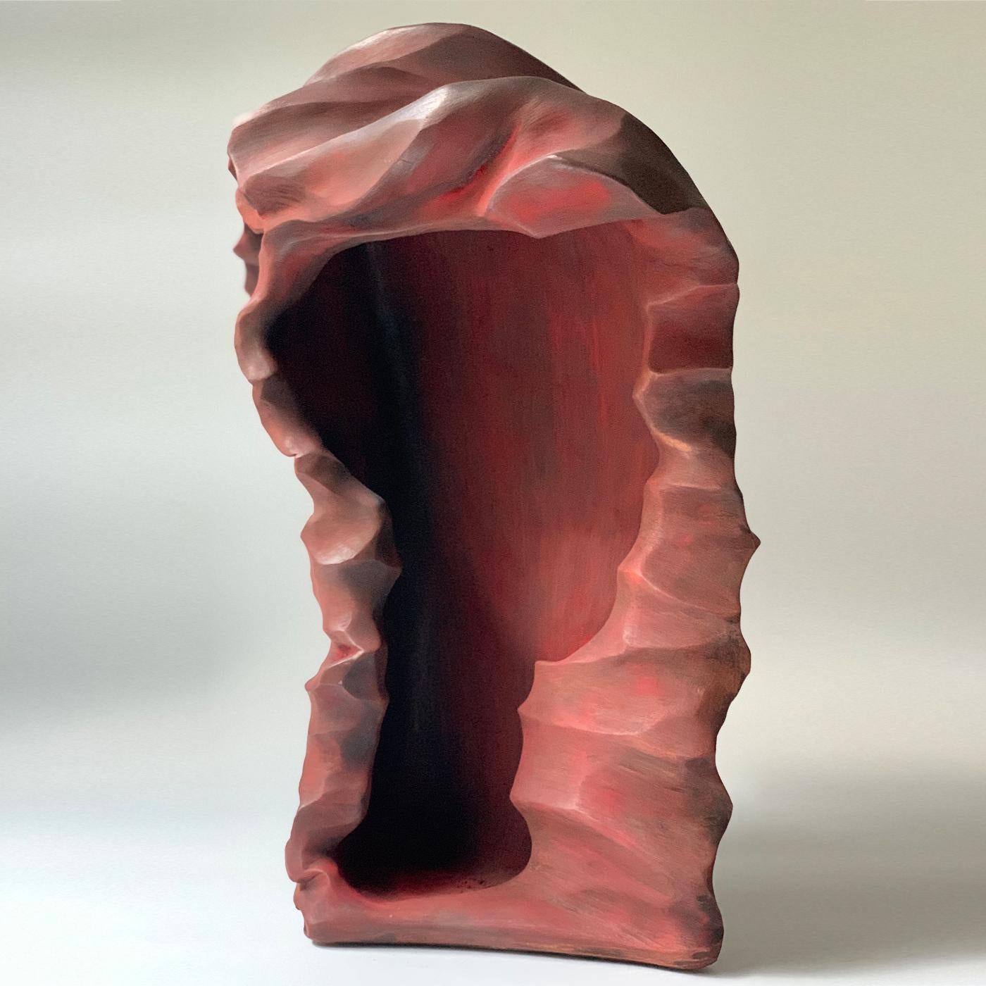 Pleasantly vibrant and sinuous in its seductive movement and pure red pigment coloring its entire shape, this stupendous sculpture can be looked at from three main angles. Handcrafted of ceramic painted in an intense, almost incandescent shade, it