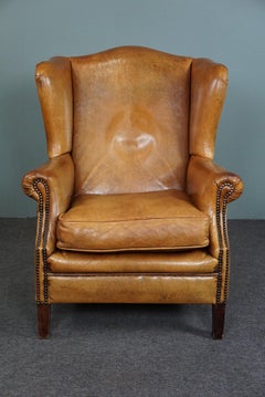 Speaking cognac colored sheep leather wing armchair