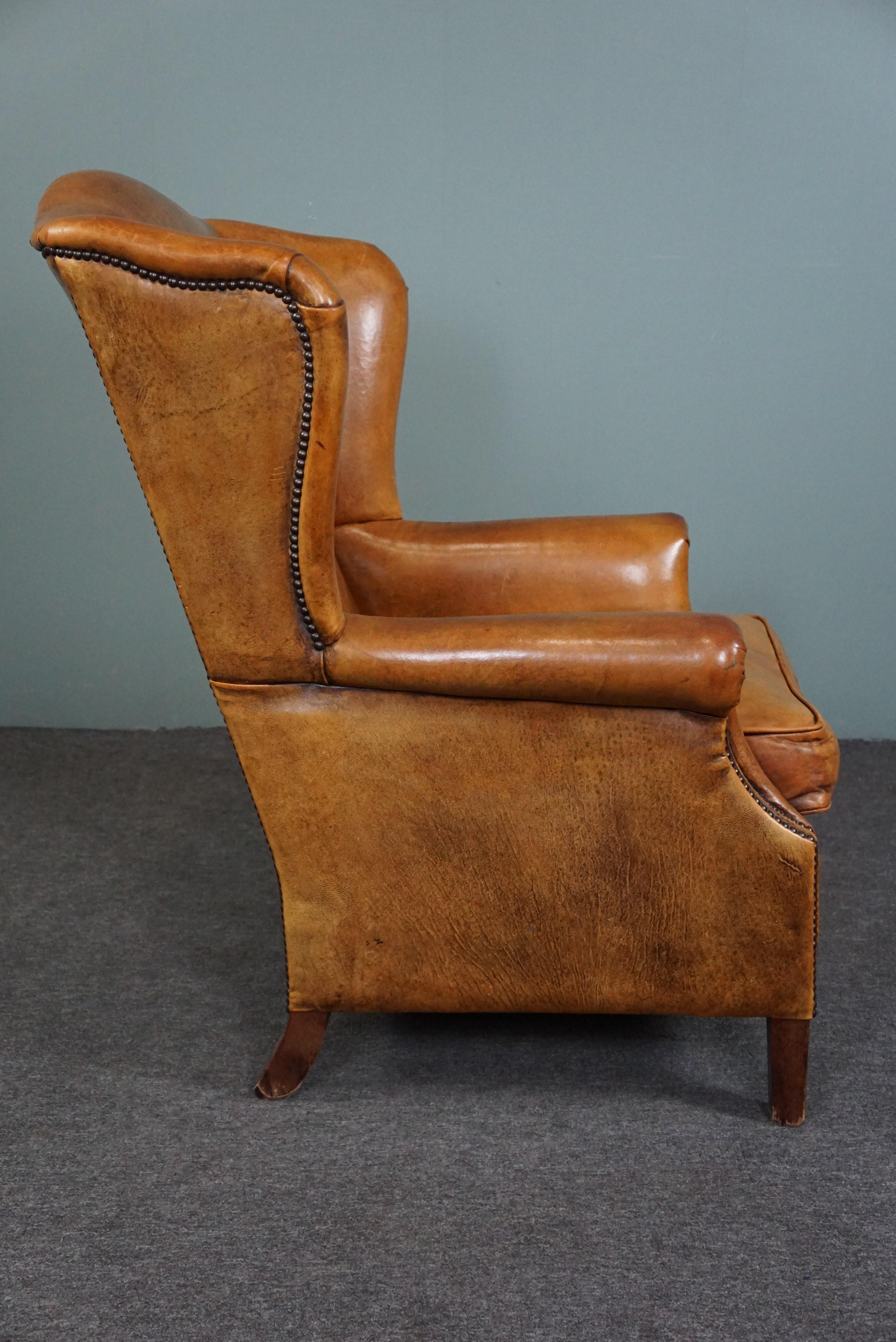 Dutch Speaking cognac colored sheep leather wing armchair For Sale