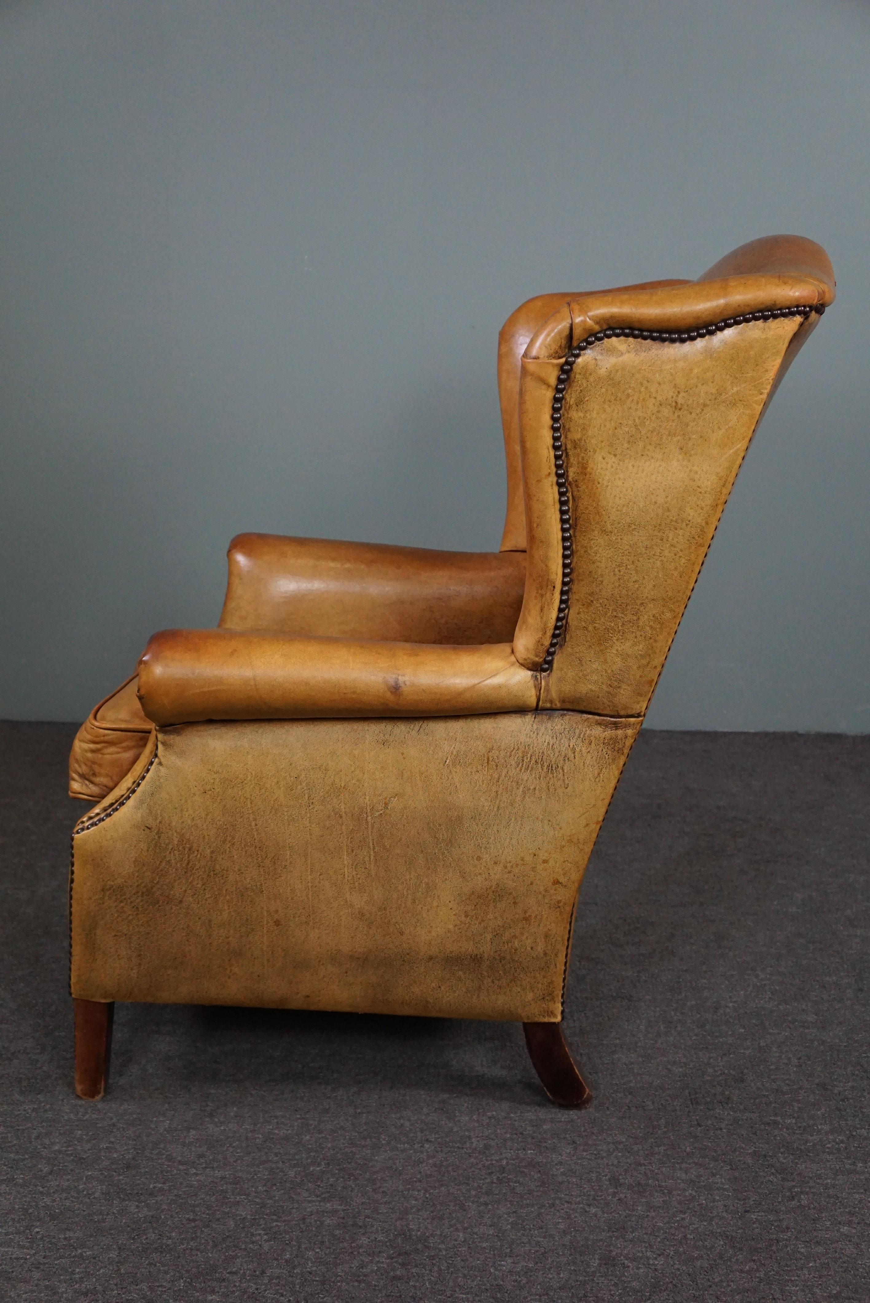 Speaking cognac colored sheep leather wing armchair In Good Condition For Sale In Harderwijk, NL