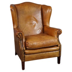 Speaking cognac colored sheep leather wing armchair