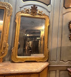 Gilded mirror with carved floral cimasa, Italy
