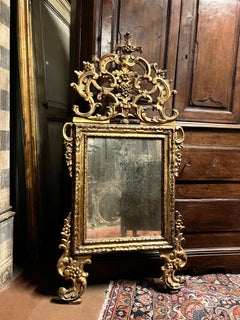 Gilded mirror with richly pierced cimasa, Italy