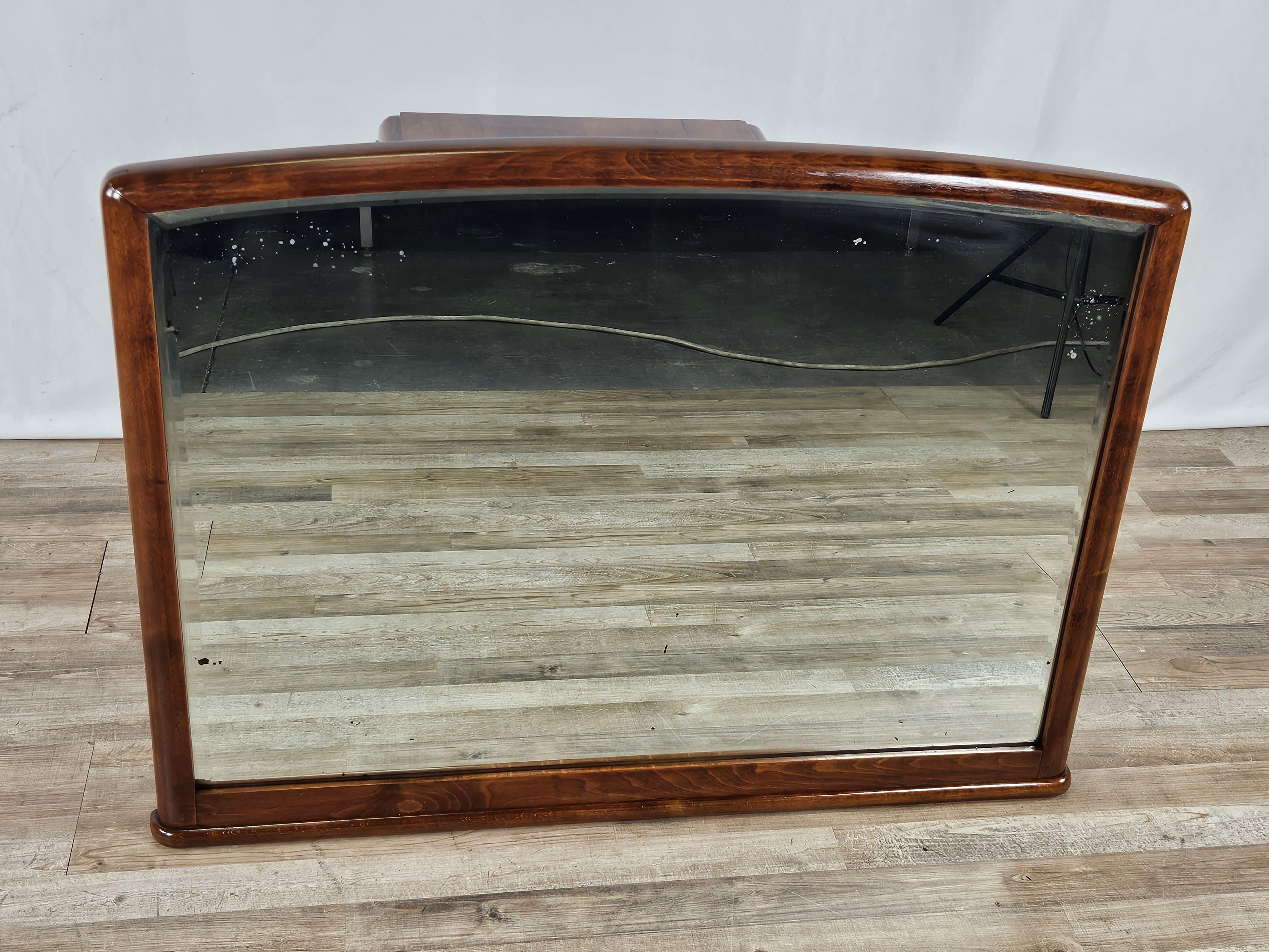 1940s Art Deco briarwood mirror with beveled glass original to the period.

It comes from a dresser.

The frame has been oil and shellac polished, ready to be placed on a credenza top or in an entryway with a console table.