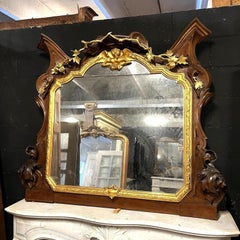 Monumental mirror made of carved walnut and gilded wood, late 19th century