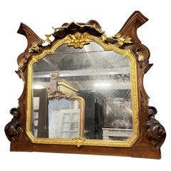 Monumental mirror made of carved walnut and gilded wood, late 19th century