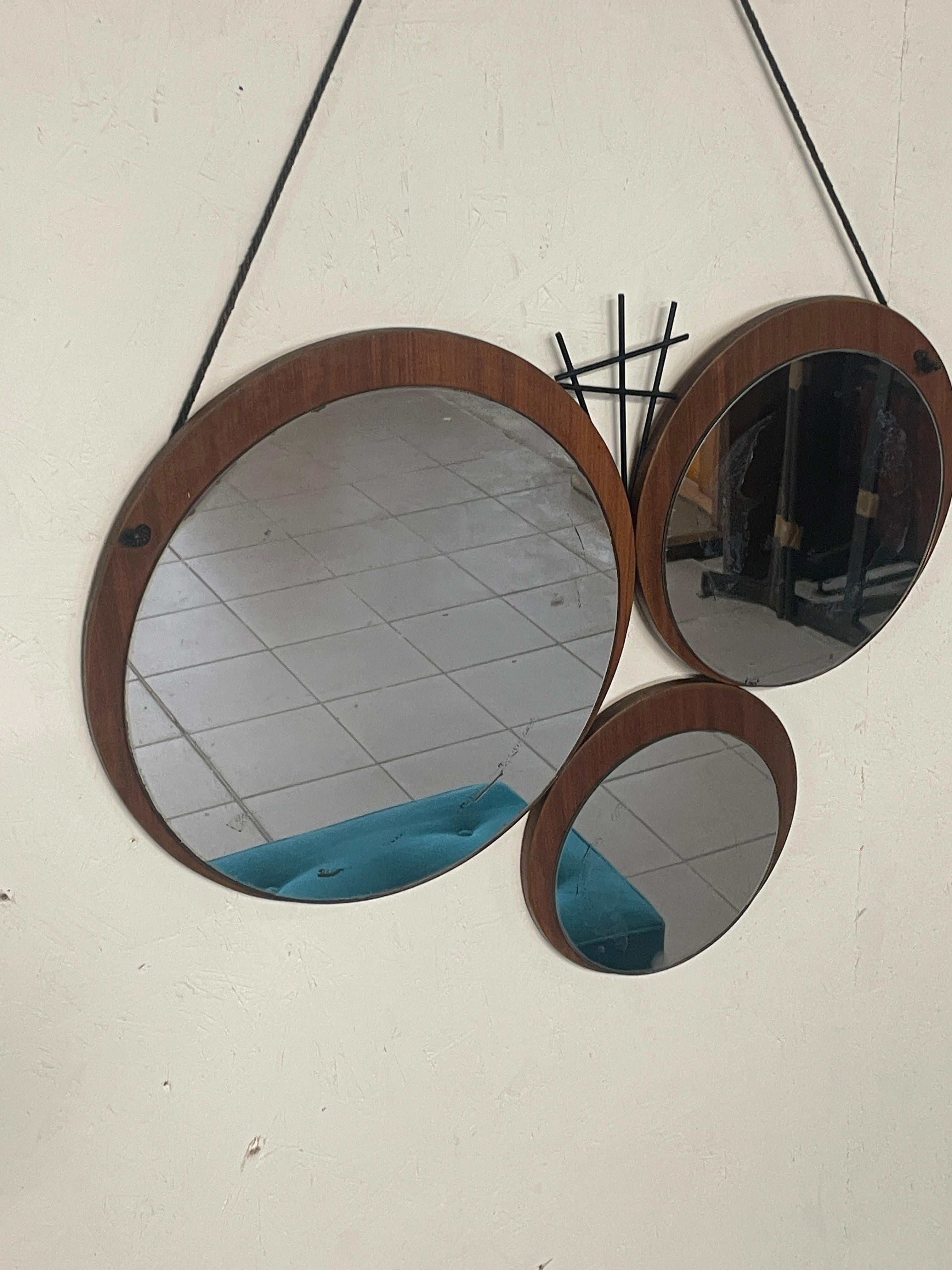 Metal 1960s mirror with geometrically patterned teak base For Sale