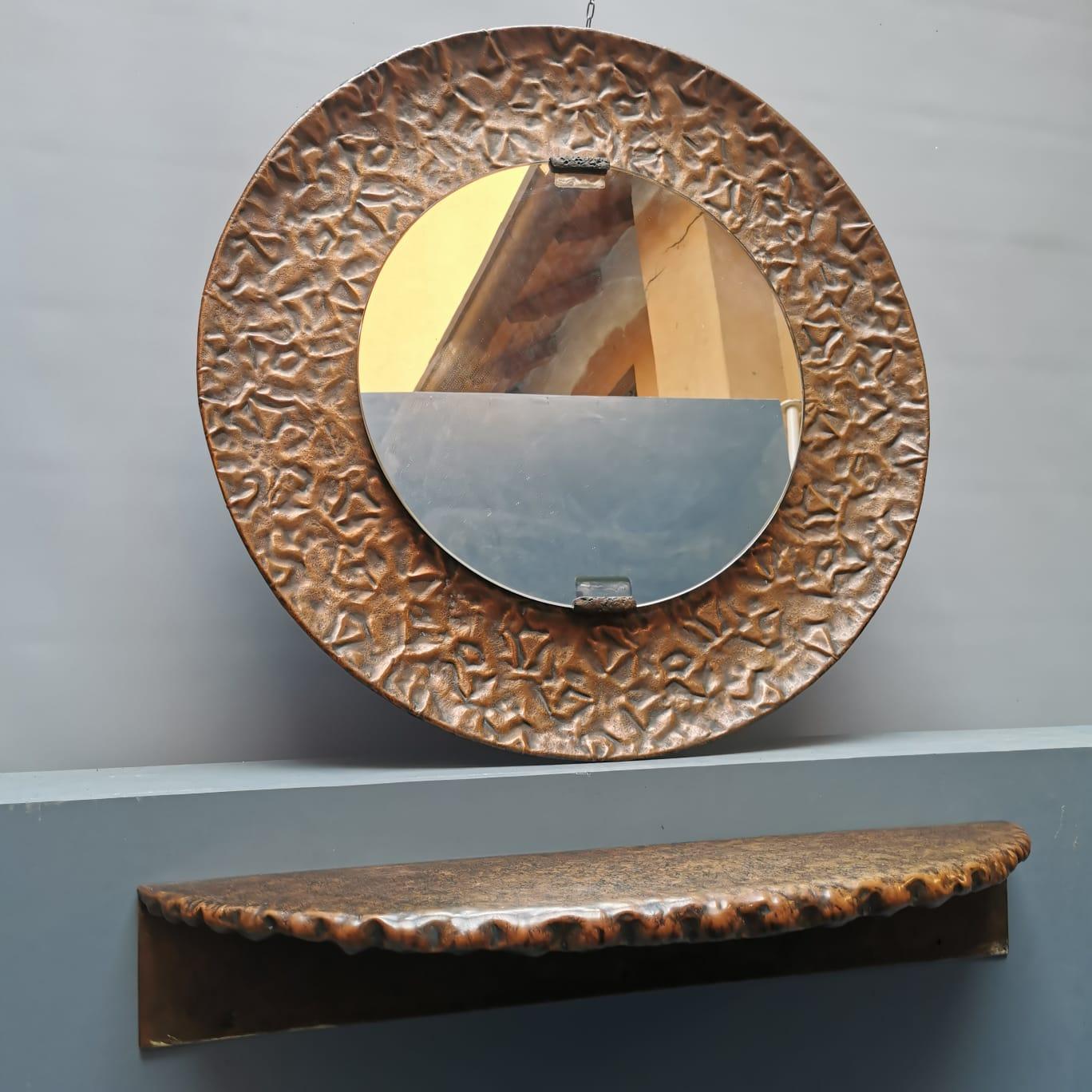 Mirrored crystal wall mirror with cantilevered and hammered copper frame with cantilevered copper shelf made by Angelo Bragalini, sculptor, goldsmith, decorator, painter and designer. Working with a spectrum of materials and using techniques such as