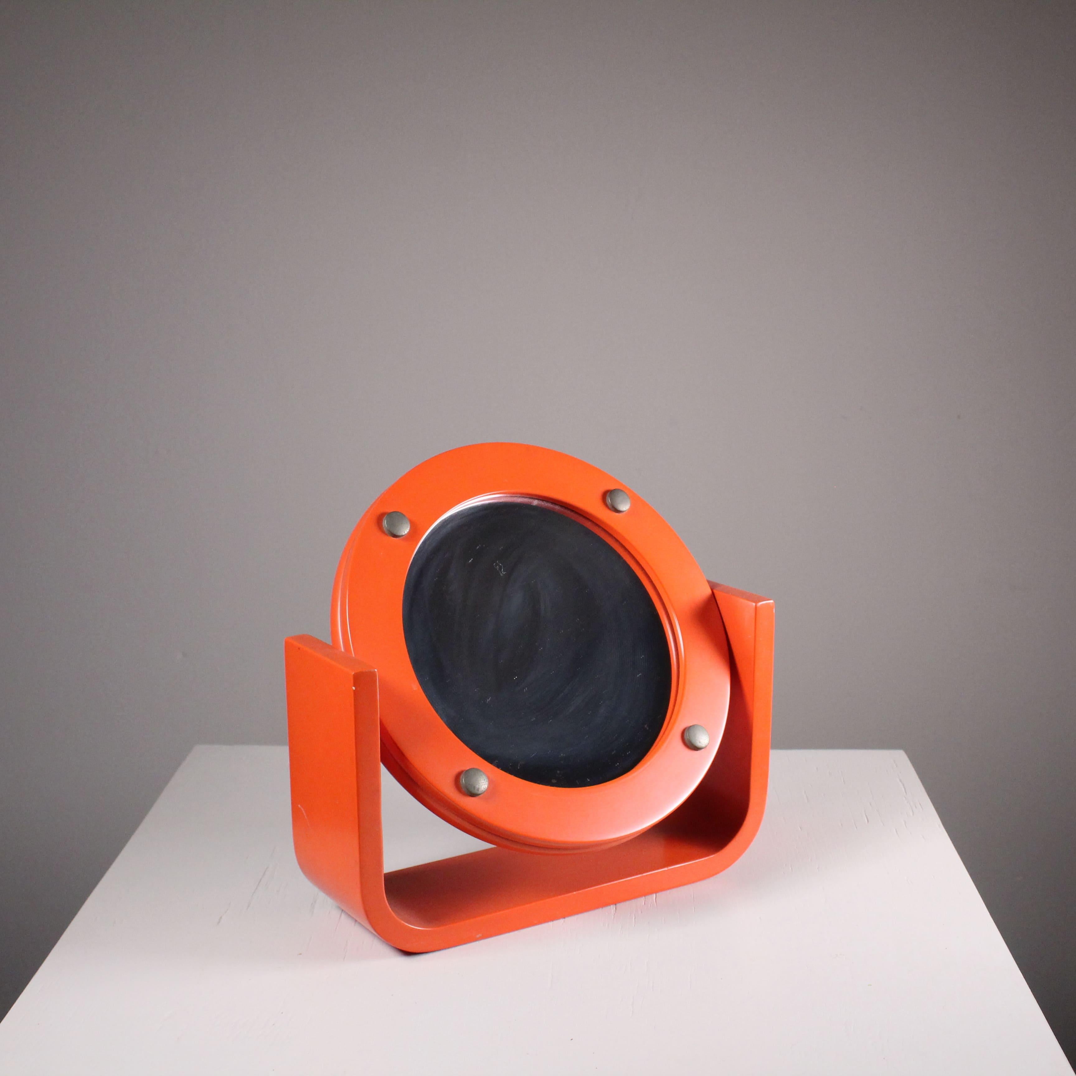 Orange table mirror, 1960s, small superficial marks .