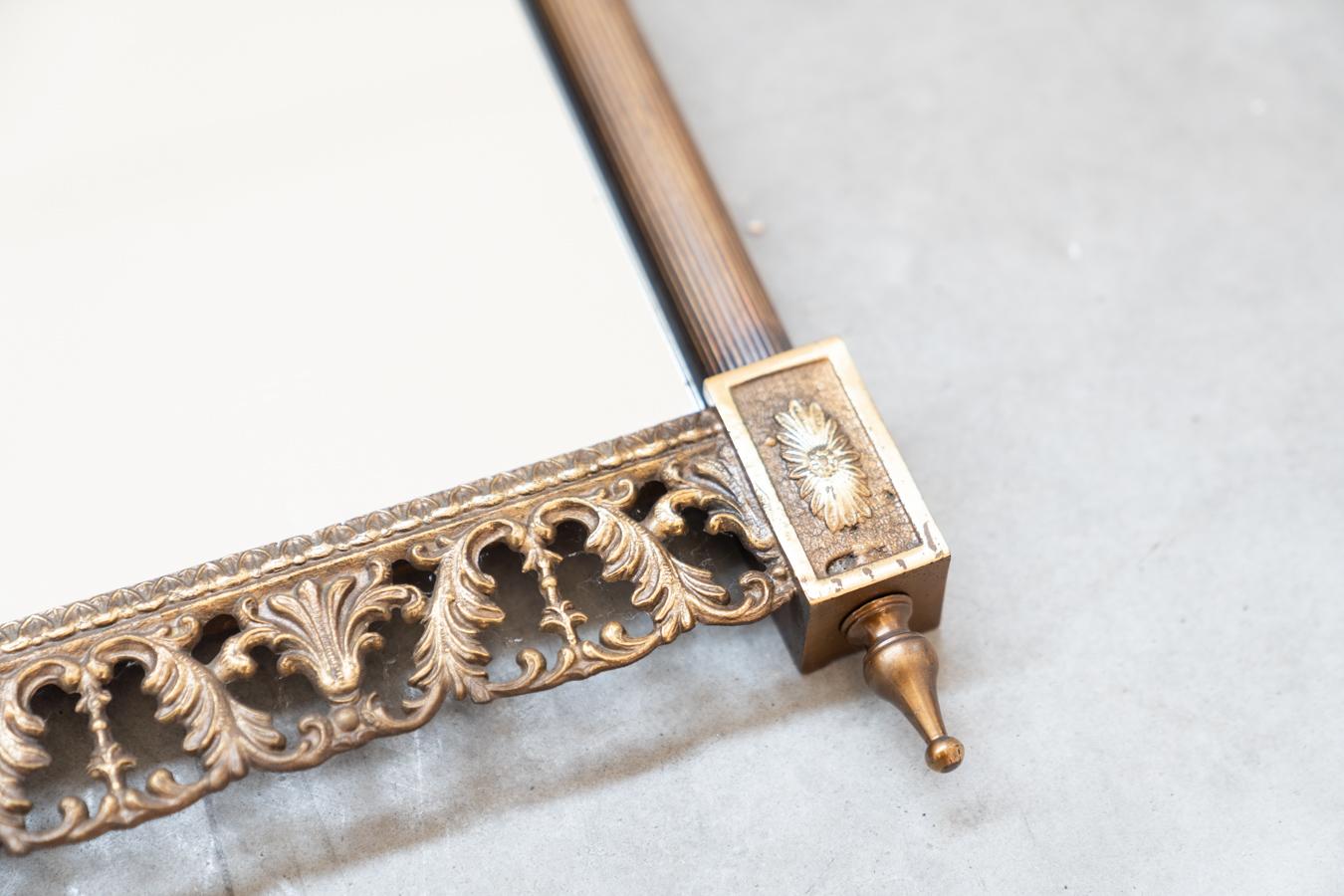 Mid-20th Century Wall mirror, brass with carved and pierced profiles at the top and For Sale