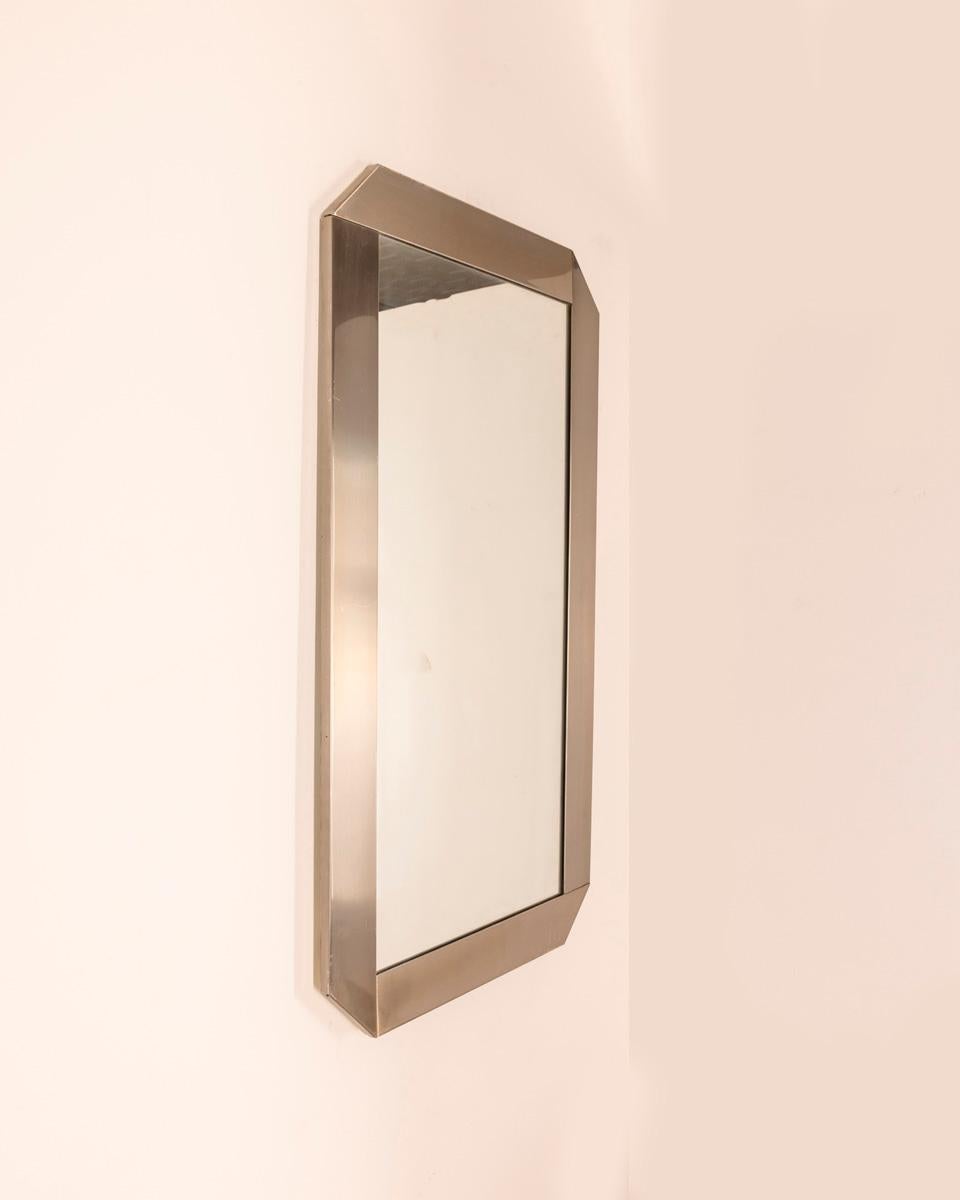 Wall mirror with chromed metal frame, design Gaetano Sciolari for Valenti, 1970s.

CONDITION: In good condition, may show signs of wear given by time.

DIMENSIONS: Height 97 cm; width 55 cm; length 2 cm;

MATERIALS: Metal and Glass

YEAR OF