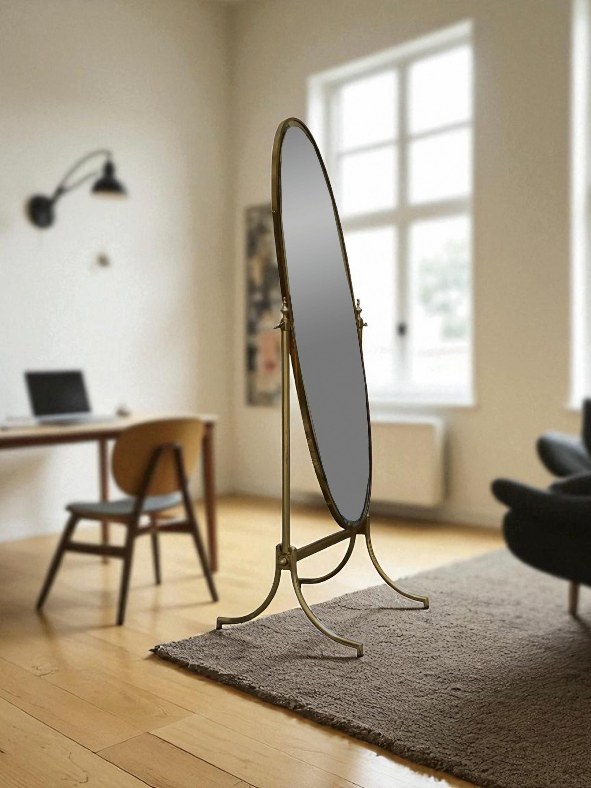 Beautiful tilting floor mirror with oval ground mirror supported by a cast brass frame. 
The mirror is in exceptional condition, free of chips, cracks, or damage.  The mirror can be tilted in the frame to adjust its position.