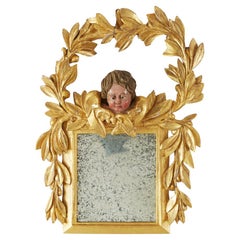 Espejo italiano tallado en madera dorada con guirnalda de laurel y putto 1800