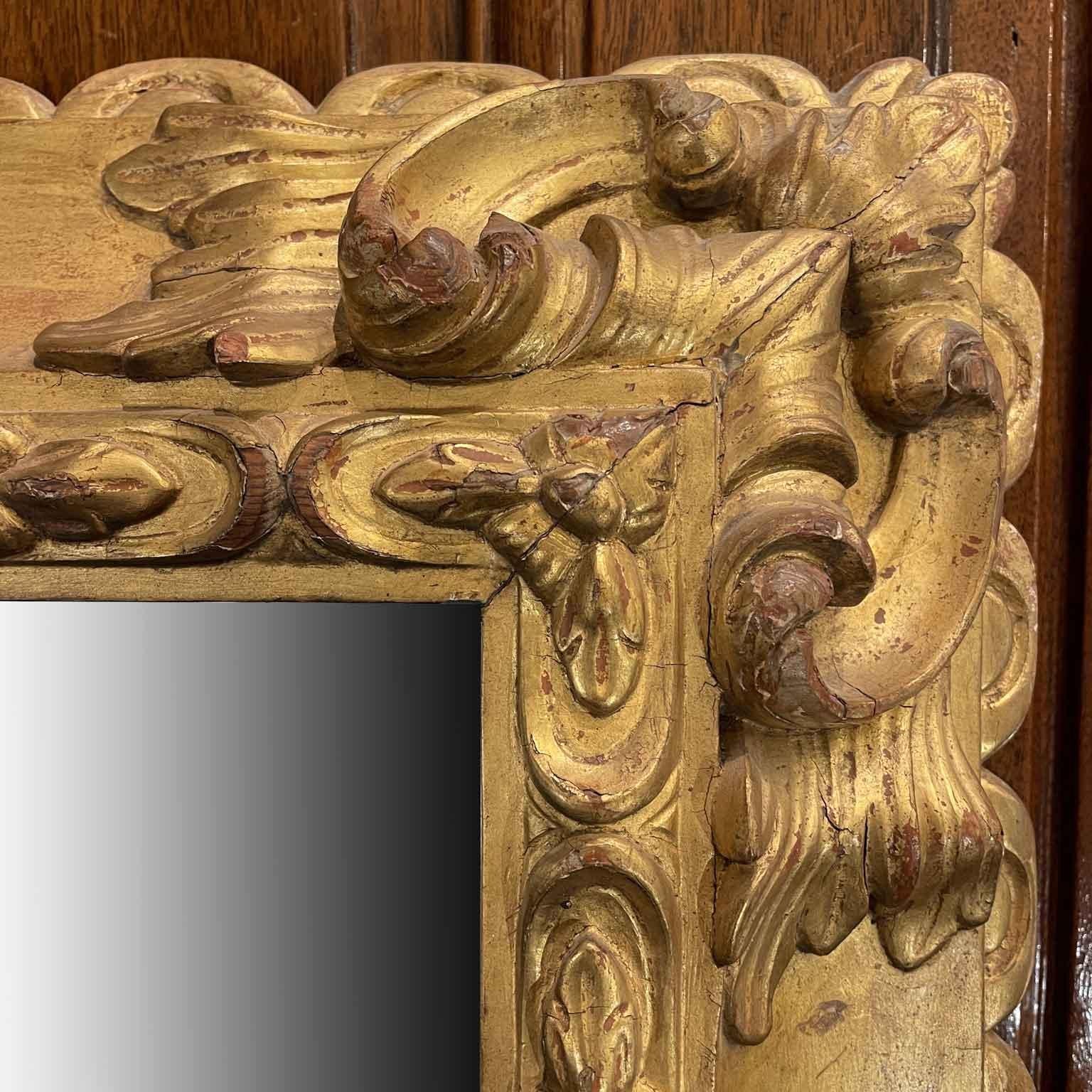The Carved and Gilded Mirror we offer is a fascinating example of late 19th-century Italian craftsmanship. Made of larch wood, its design  carving lends a special elegance, highlighted by the leaf motifs and scrolls that decorate the corners and