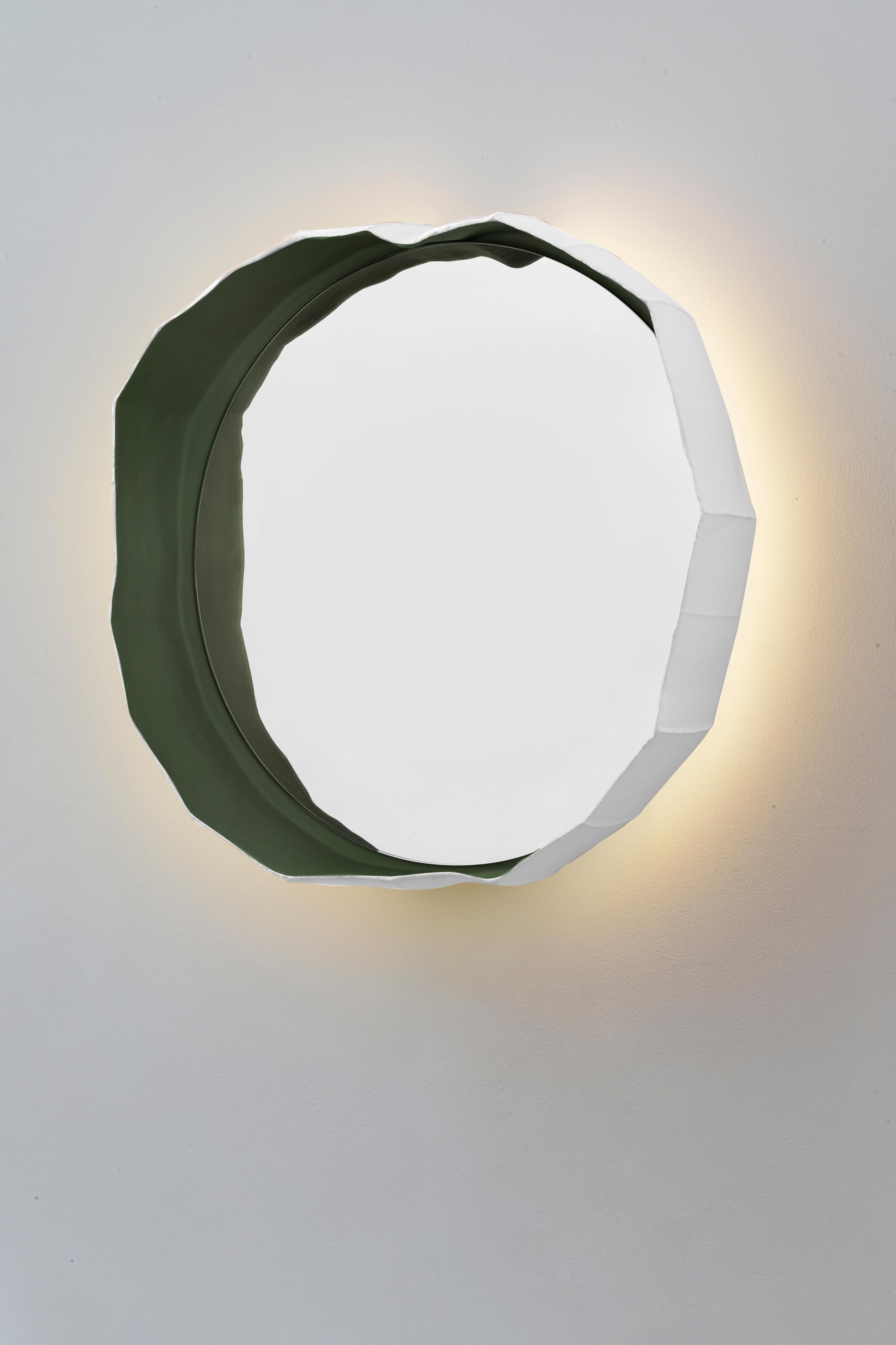 Handmade in Italy by Paola Paronetto & Giovanni Botticelli, this mirror merges ceramic with glass. REFLECTIONS, a fusion of distinctive materials developed by their creators, unites an apparently light material such as paper clay with the crisp