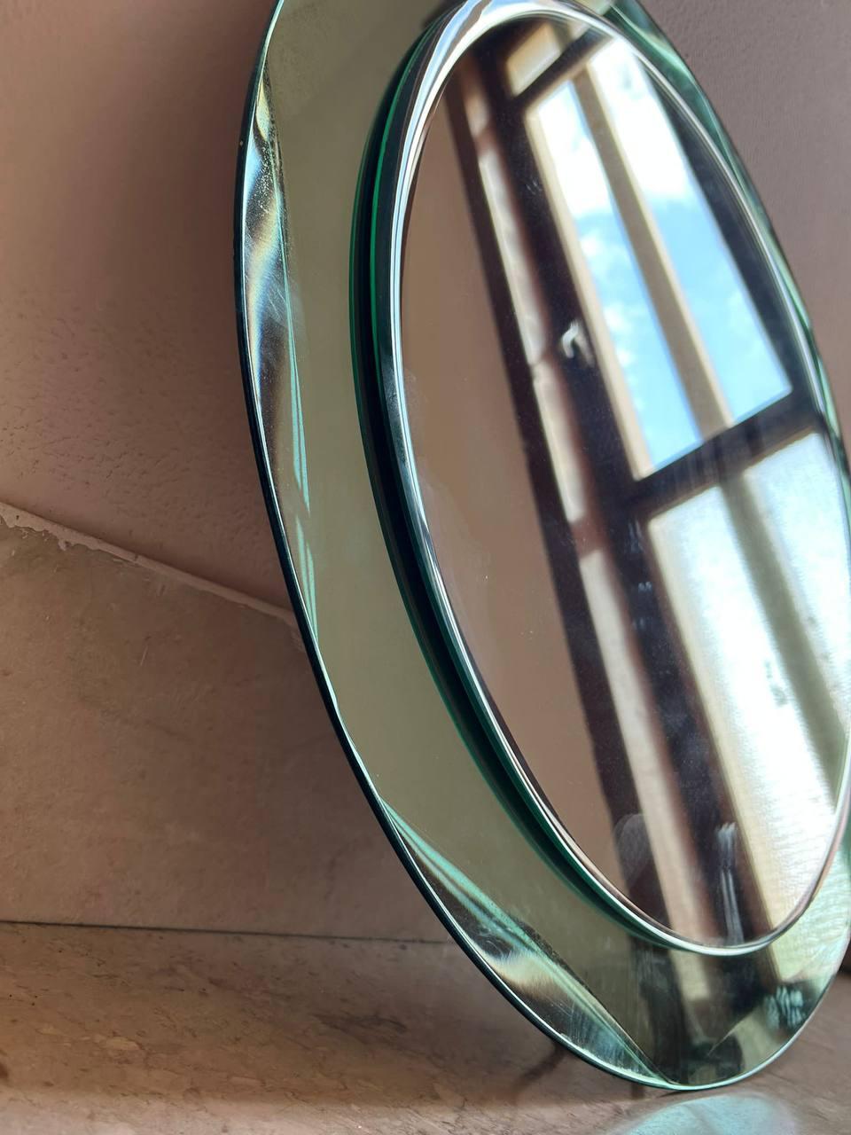 Beautiful mid-century oval mirror with teal frame . This Italian mirror is in the style of Cristal Arte and was designed in Italy during the 1960s.
This piece is an example of excellent Italian manufacture with a double mirror layer.
The shiny frame