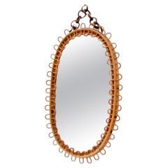 Oval wicker and bamboo mirror in the style of Franco Albini
