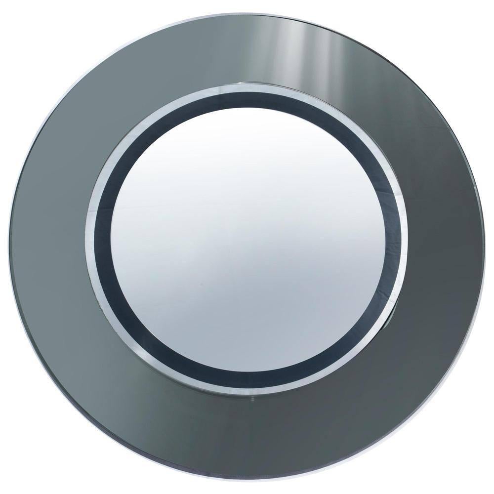 Miroir mural circulaire Cristal Art, 1960s

Ce miroir incarne l'élégance du design italien des années 1960, produit par la célèbre société Cristal Art. Sa forme circulaire, avec un motif de cercles concentriques, crée un point focal sophistiqué dans