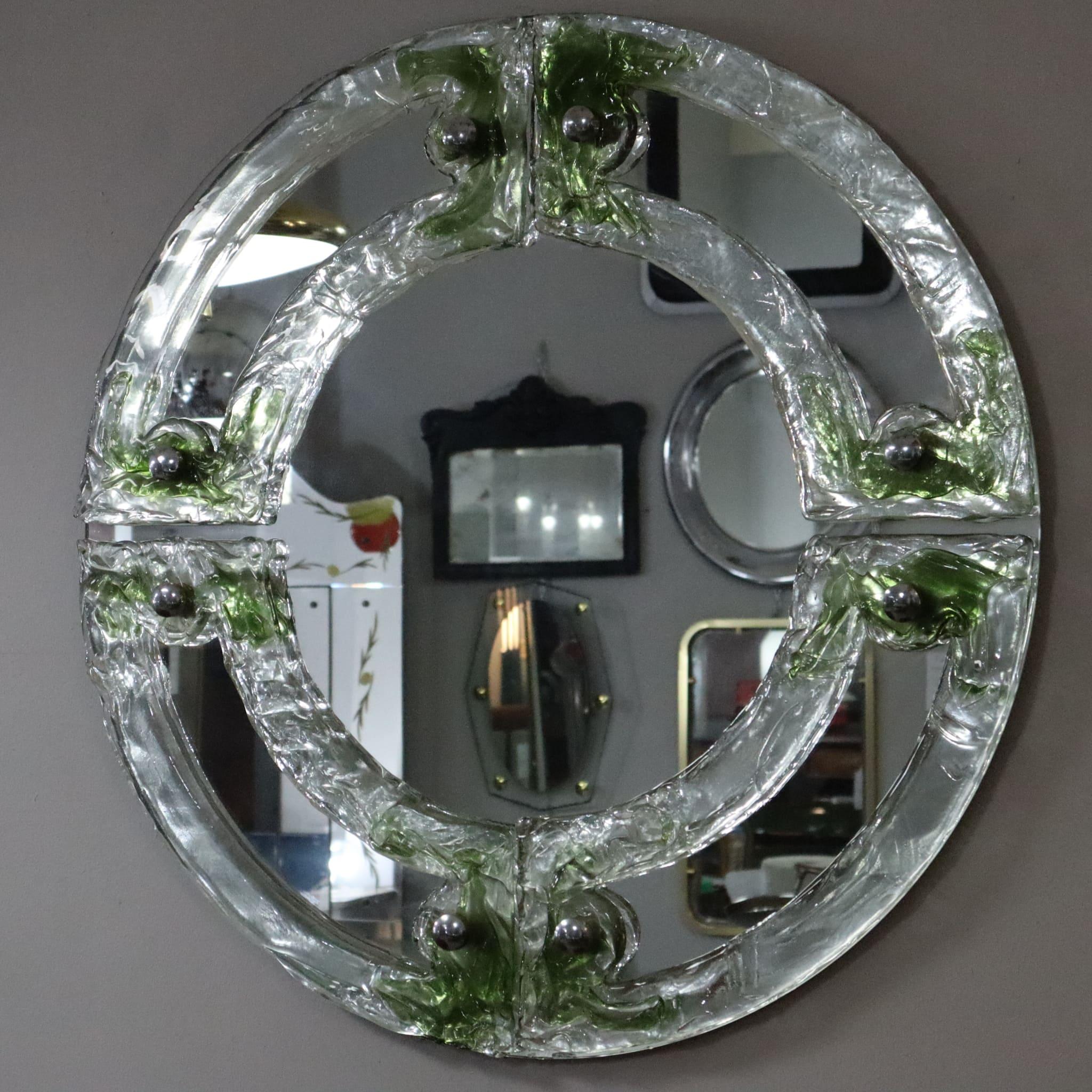 Mid-century Round Green Murano Glass Italian Mirror by Mazzega, 1960s
This round mirror, made in the 1960s, is an iconic piece by Mazzega, one of the leading Murano glass manufacturers, renowned for its craftsmanship and timeless design. The Murano