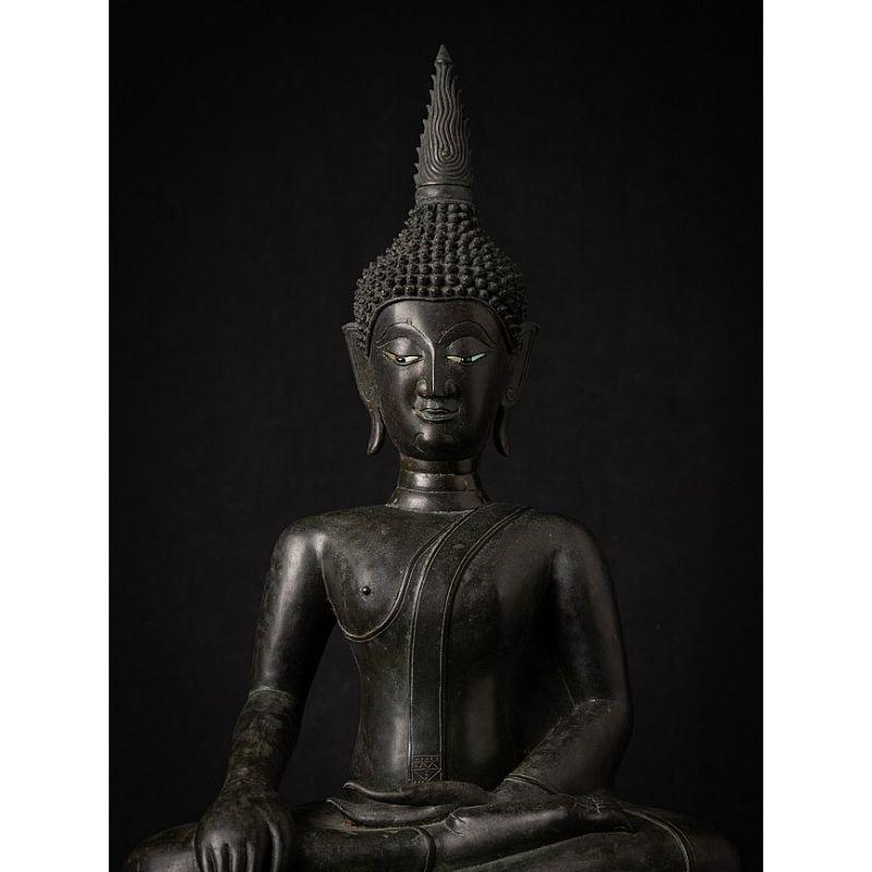 Material: bronze
60 cm high 
34,5 cm wide and 22,3 cm deep
Weight: 12.4 kgs
Bhumisparsha mudra
Originating from Laos
16th century
With inlaid eyes of mother-of-pearl
Long neck with three folds, Laos Lang Chiang influences
The lower half of