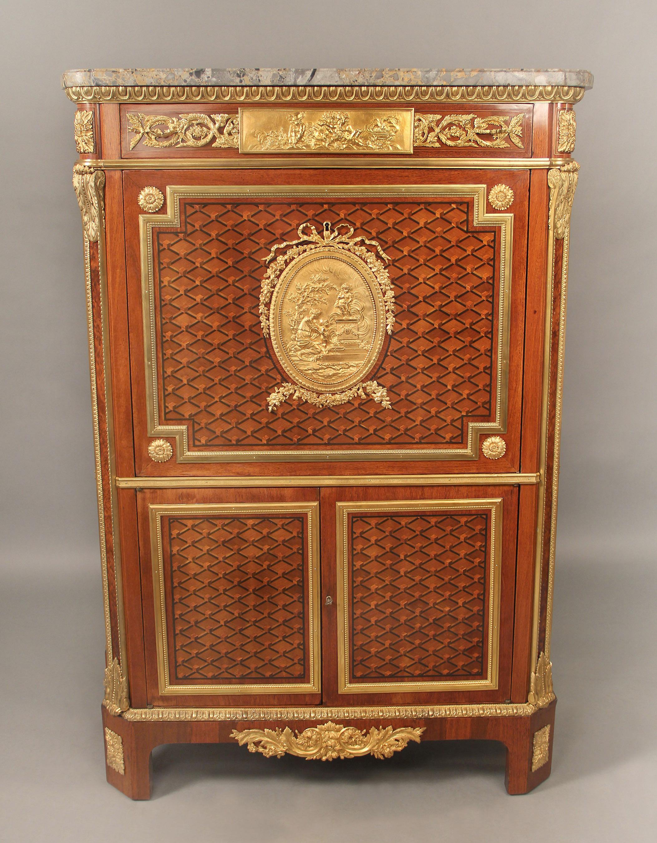 A Special Late 19th Century Gilt Bronze Mounted Inlaid Parquetry Secretaire a Abattant

The shaped marble top above a long center frieze drawer with a large central bronze plaque of putti at play, the beautiful parquetry drop-down door centered with