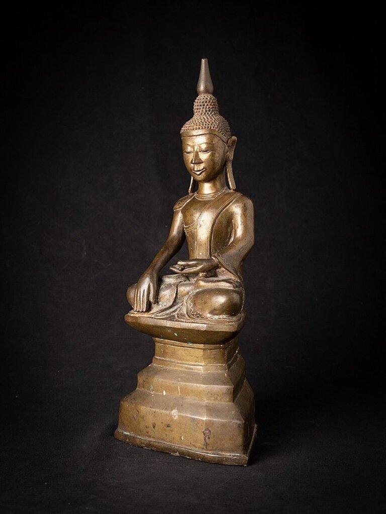 Material: bronze
43,5 cm high 
17,4 cm wide and 11,8 cm deep
Weight: 6.644 kgs
Shan (Tai Yai) style
Bhumisparsha mudra
Originating from Burma
18th century
With inscriptions on the backside of the base, probably the name of the donor of the