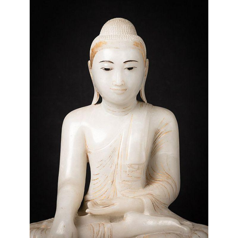 Material: marble
52 cm high 
46 cm wide and 29 cm deep
Weight: 40.15 kgs
With gilded decorations
Mandalay style
Bhumisparsha mudra
Originating from Burma
19th century
The stone seems more 'alabaster', it is translucent
Very high quality