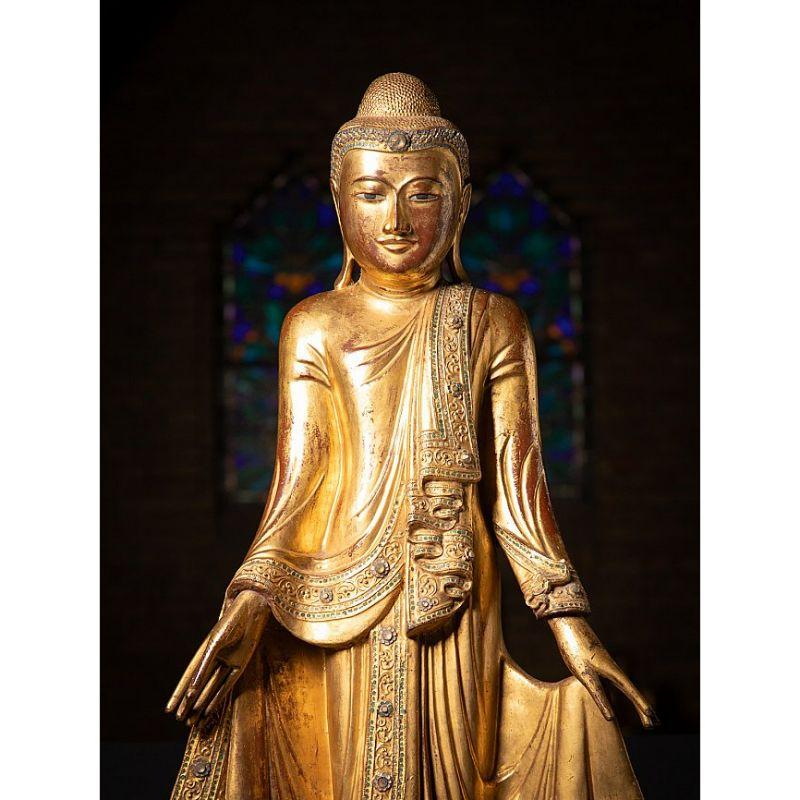 Material: wood
159 cm high 
65 cm wide and 25 cm deep
Gilded with 24 krt. gold
Mandalay style
Originating from Burma
19th century
With inlayed eyes
The height is measured including the 31.5 cm high pedestal. Pedestal is 25 x 25 cm


