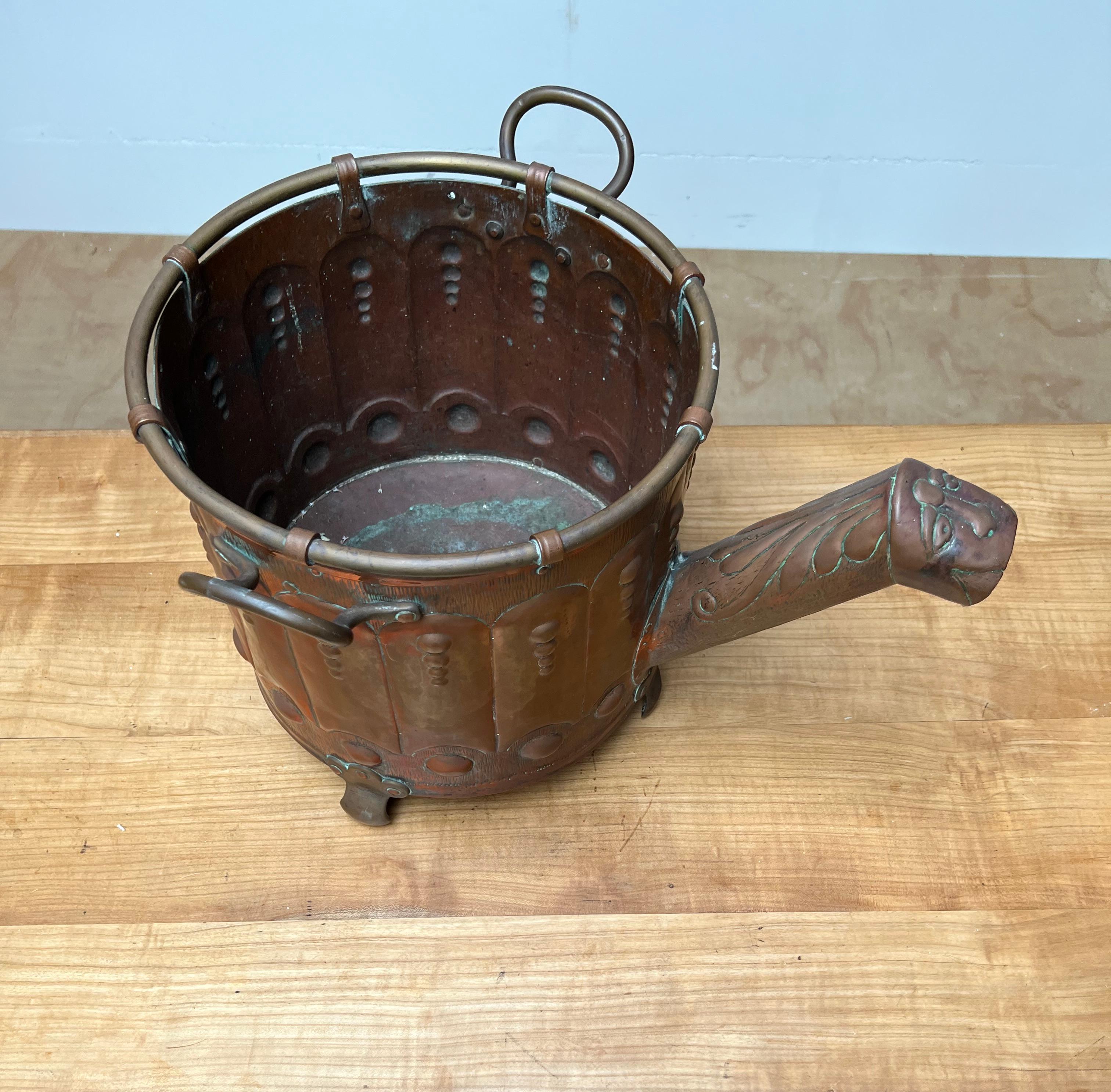 Sizeable and museum quality, embossed copper with brass handles bucket on feet.

This stunning, sturdy and heavy antique and hand-crafted bucket is another one of our recent rare finds. When used as a log bucket, this handcrafted antique can single