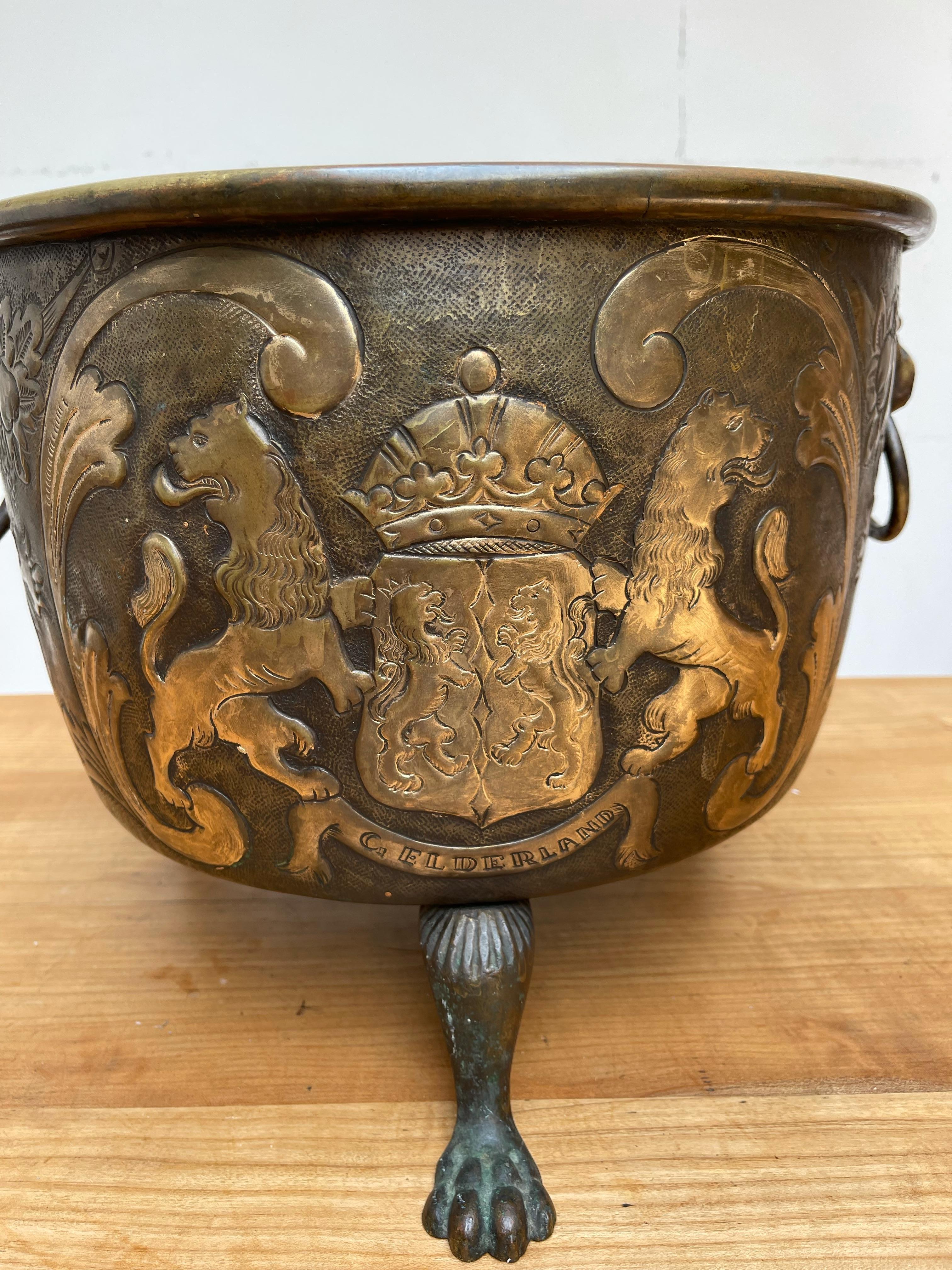 Sizeable and museum quality, embossed copper collecting bucket on lion claw feet.

This stunning, sturdy and heavy antique brass bucket is another one of our recent rare finds. When used as a log bucket, this handcrafted antique can single handedly