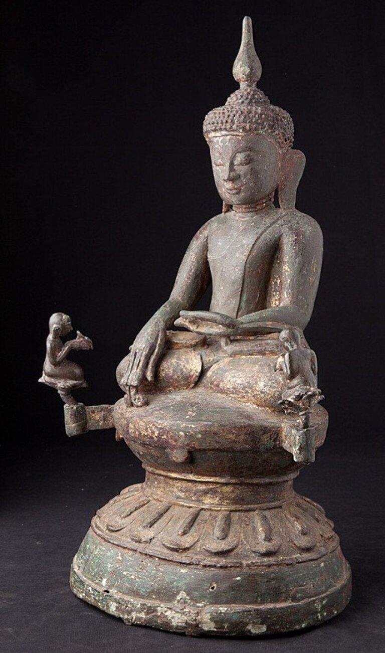 This antique bronze Buddha statue is a truly unique and special collectible piece. Standing at 51 cm high, 34 cm wide, and 21 cm deep, it is made of bronze and it weighs 11.18 kgs. The intricate details on the statue are with traces of 24 krt