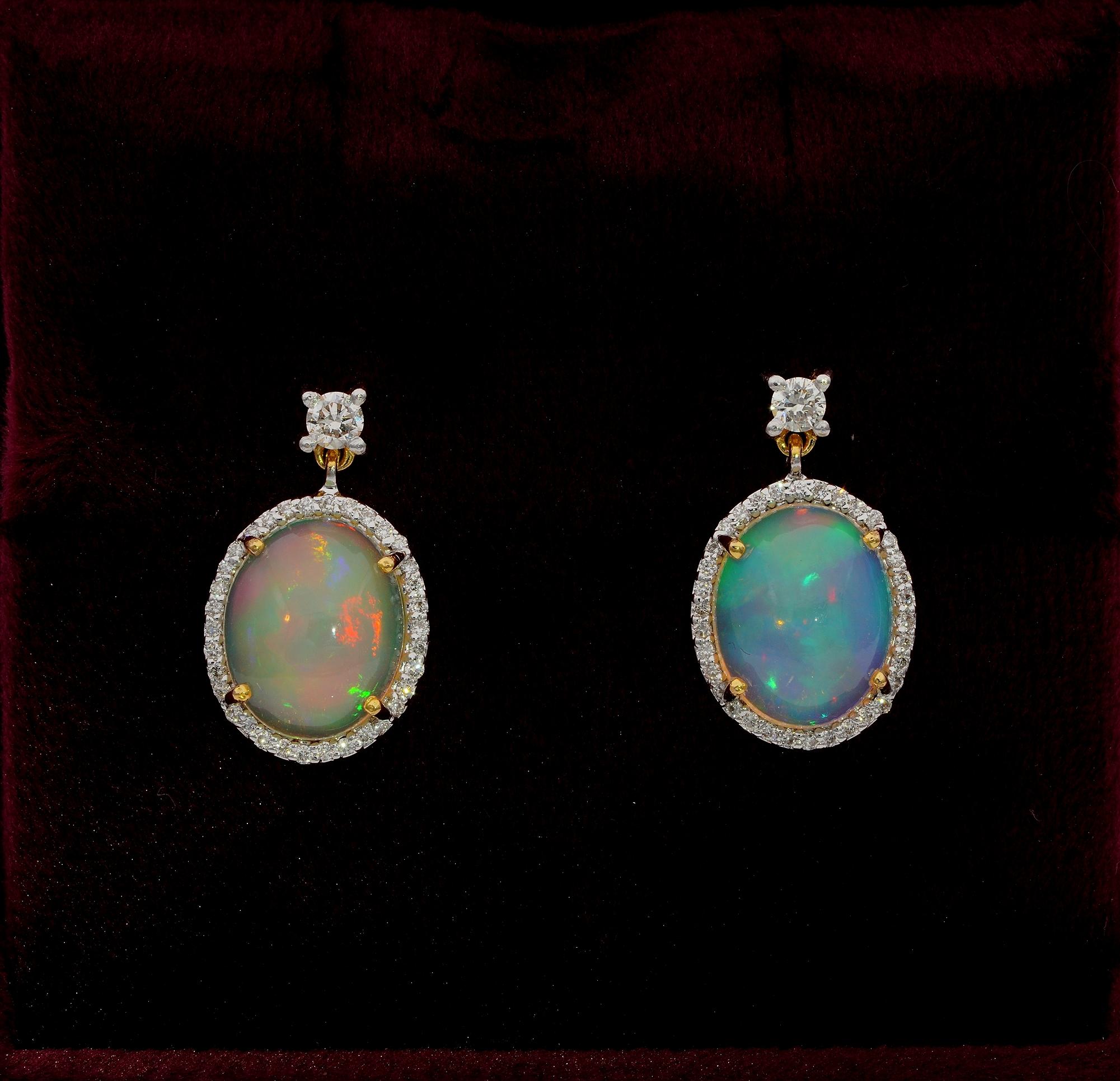 Magic Rainbow Dropping from Ears

Mesmerizing Opals are the star of these ear drops
Designed as swinging oval drops with two Opals surrounded by a halo of Diamonds topped by a small solitaire – hand crafted of solid 18 KT gold
Two deep cut natural