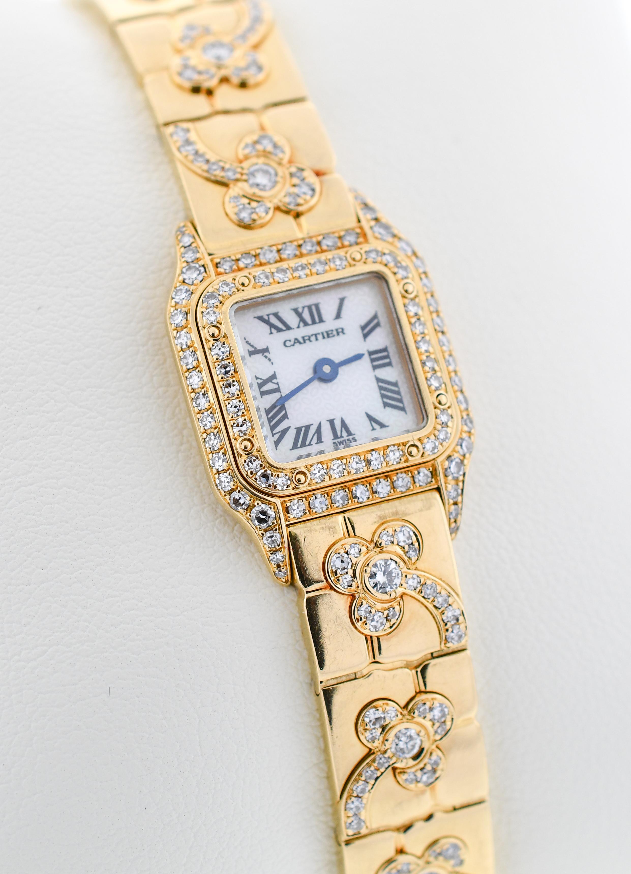 18 karat yellow gold flexible link bracelet accented by thirteen (13) diamond set flowers {each flower containing fifteen (15) round diamonds}.
The wristwatch features a double row diamond set bezel with diamond set lugs accented by eighty four (84)