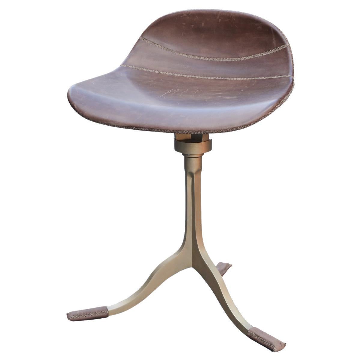 Special height stool with swivel in sand cast brass base and leather seating  For Sale